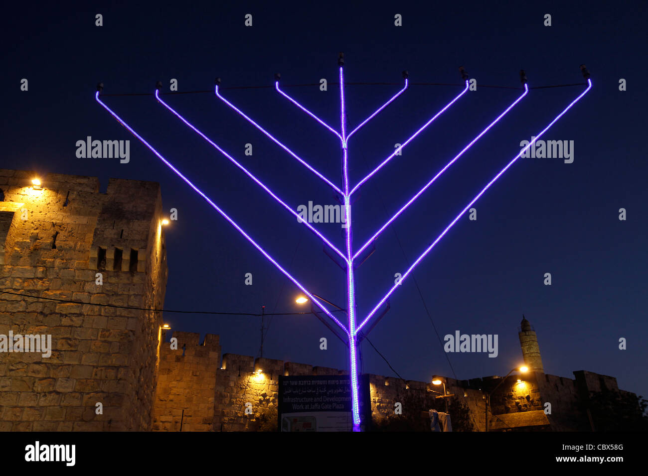 Giant illuminated Jewish Menorah candelabrum placed in front of David