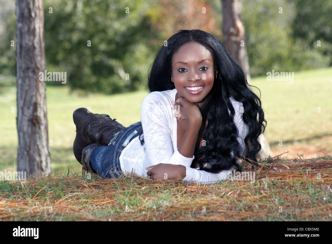 Beautiful Young Woman Lying in the Grass (2 Stock Photo - Alamy