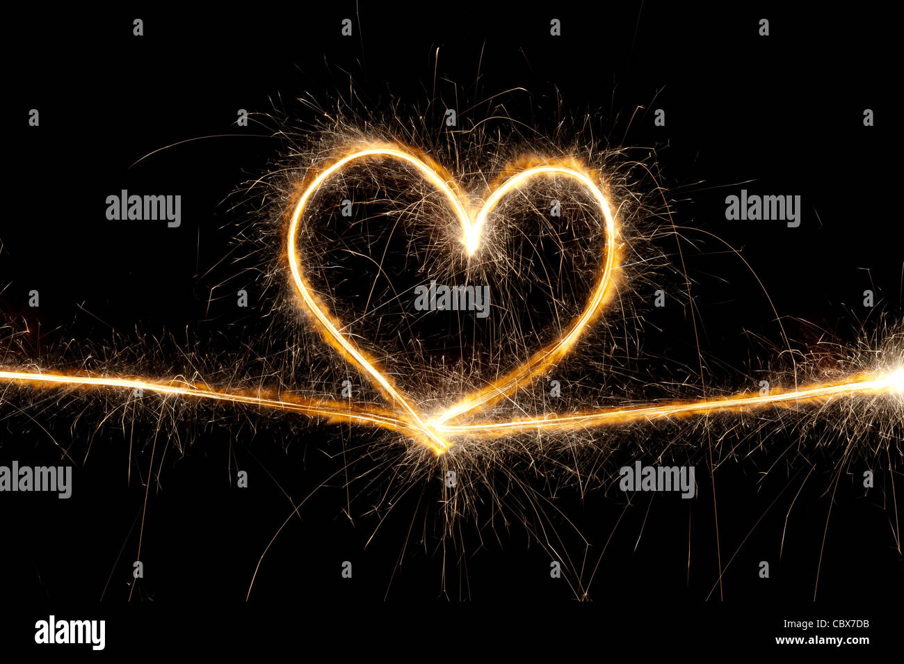 Heart shape made with sparkler at night. Stock Photo