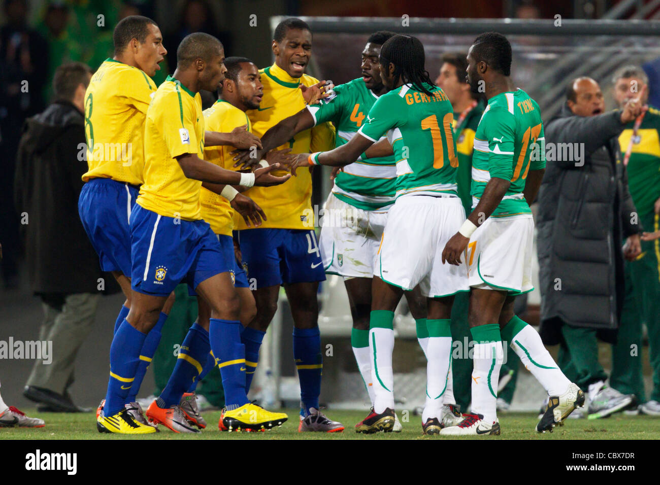 Brazil and Ivory Coast players push and shove each other during a 2010 FIFA World Cup match at Soccer City Stadium. Stock Photo