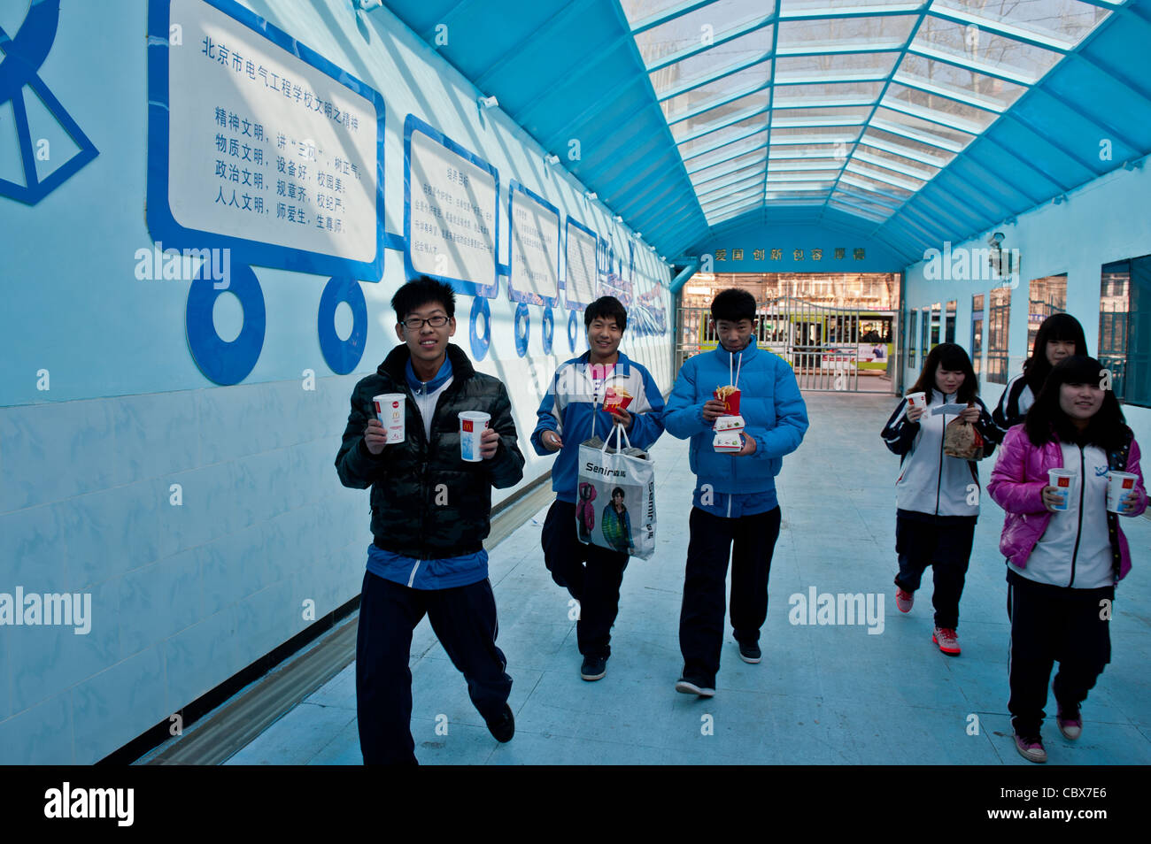 Beijing, Students with McDonald's take away food at the entrance of the Beijing Electrical Engineering School Stock Photo