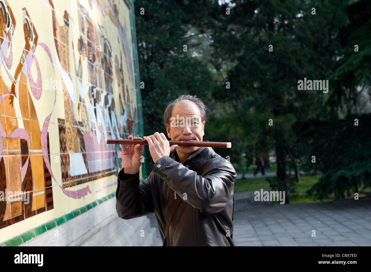 Beijing, Ritan Park. Man playing flute. Stock Photo
