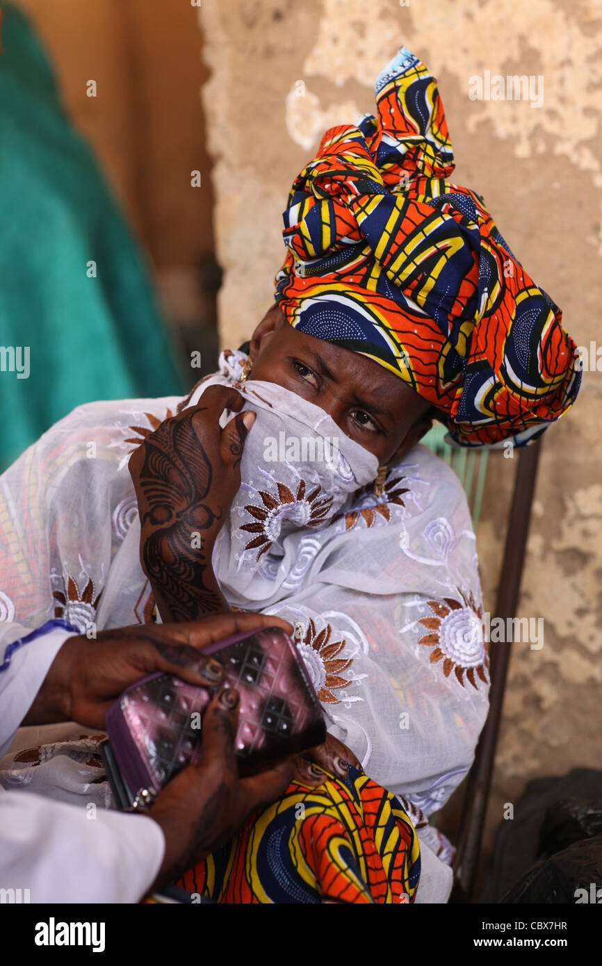 Woman at the market of Djenne, Mali, Africa, with tribal tattoos on hands and feet Stock Photo