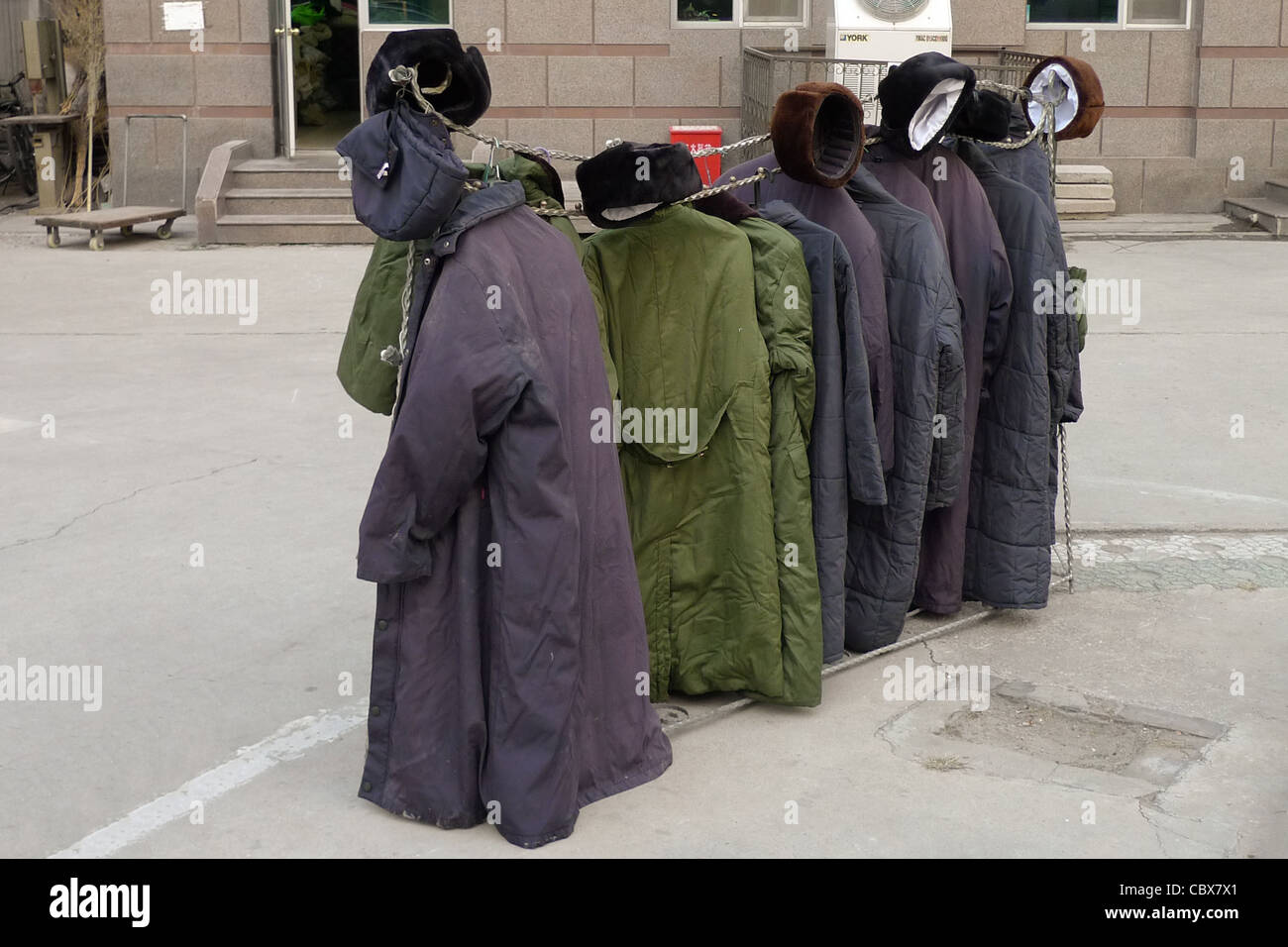 Beijing, China. Rack with coats and hats of security guards. Stock Photo