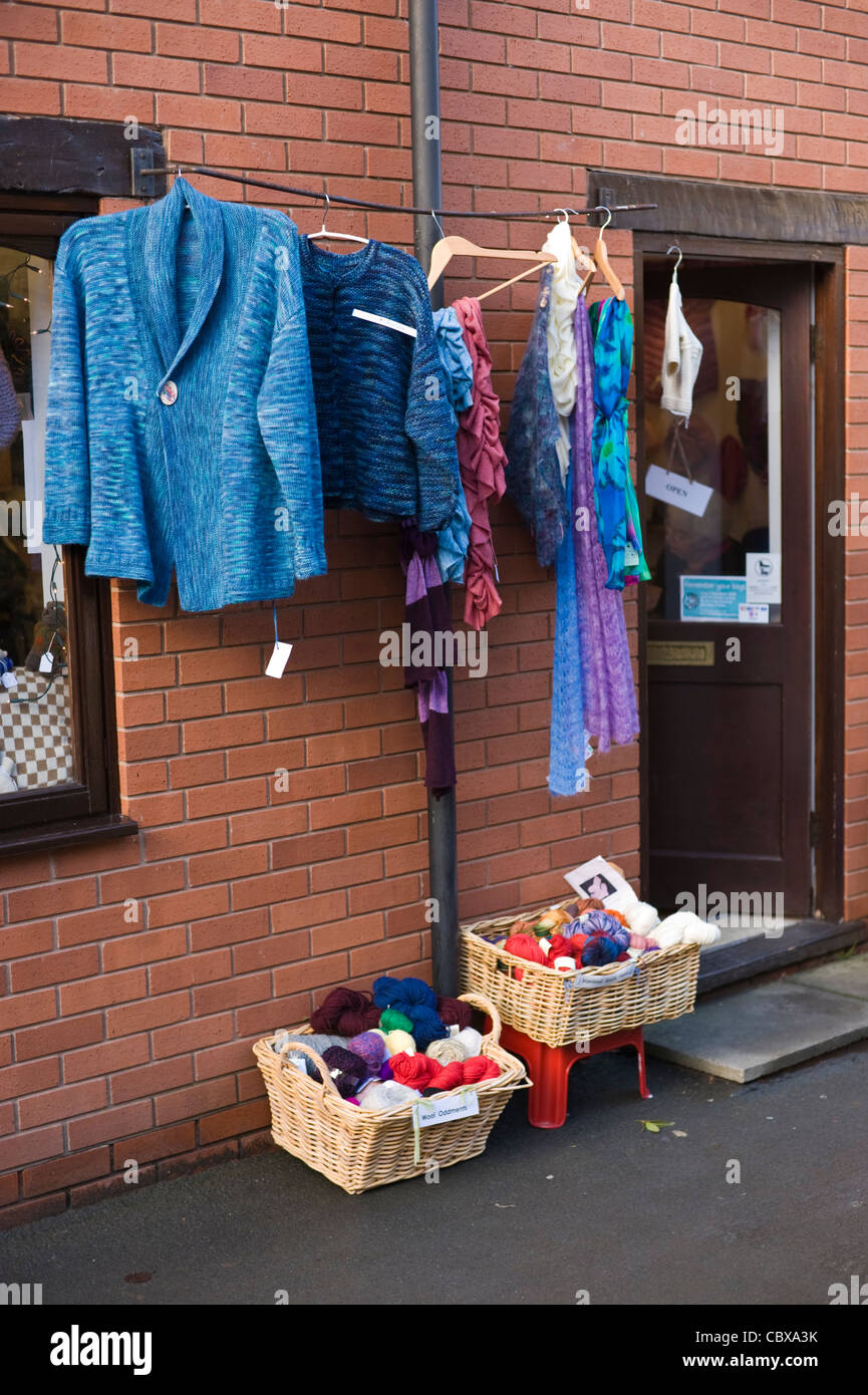 Exterior of wool shop with clothes on display hanging outside in Hay-on-Wye Powys Wales UK Stock Photo