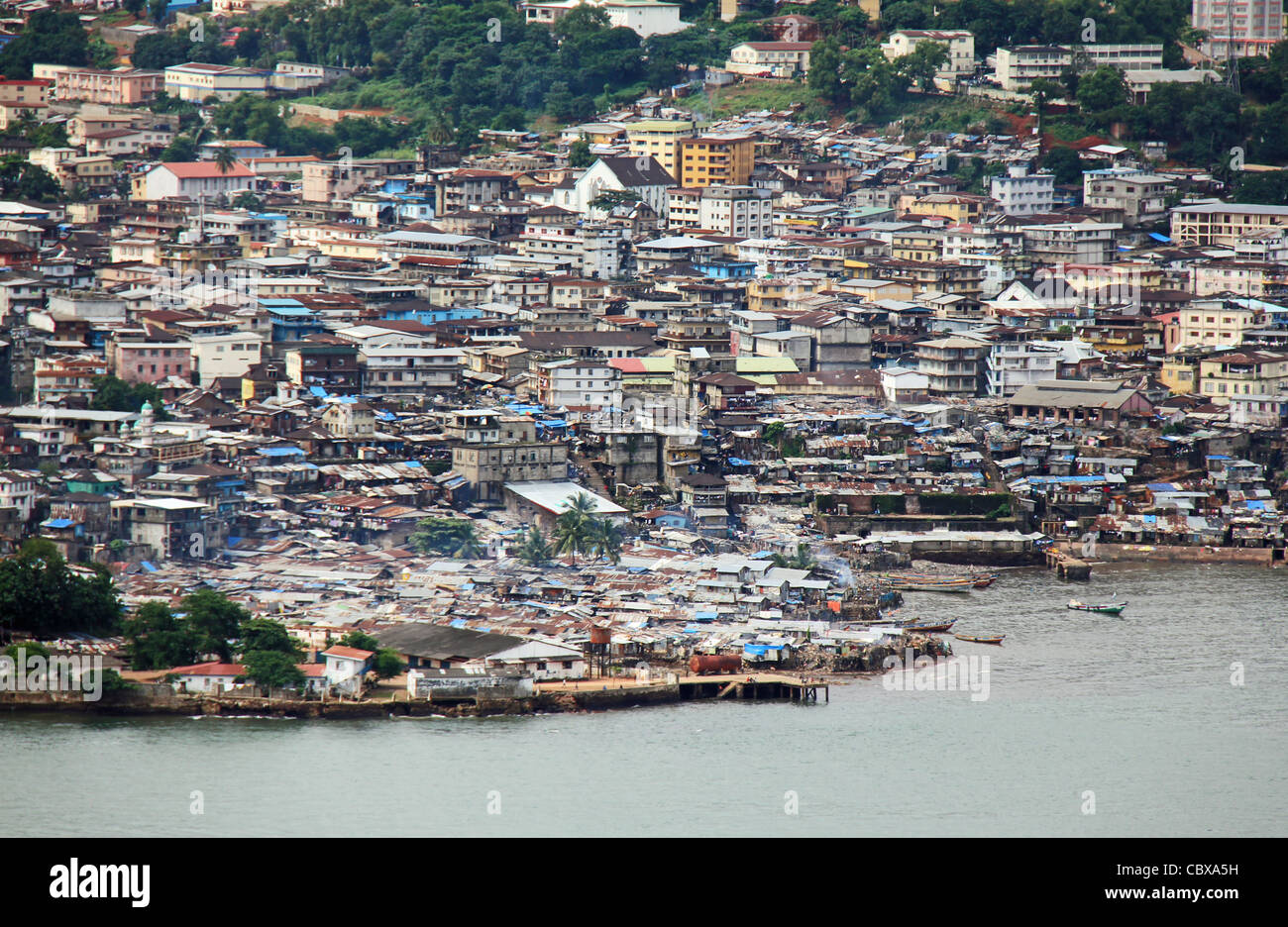 Aerial view of Freetown, Sierra Leone, with coastal slum areas in the foreground. Stock Photo