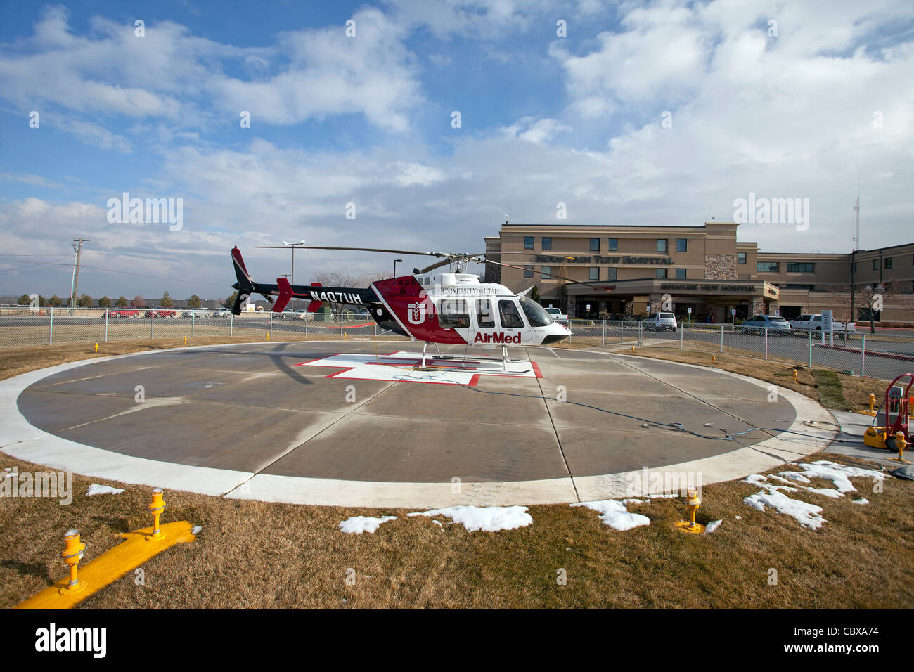 Helicopter AirMed from University of Utah Medical Center ready for emergency flight in front of a small hospital. Helipad. Stock Photo