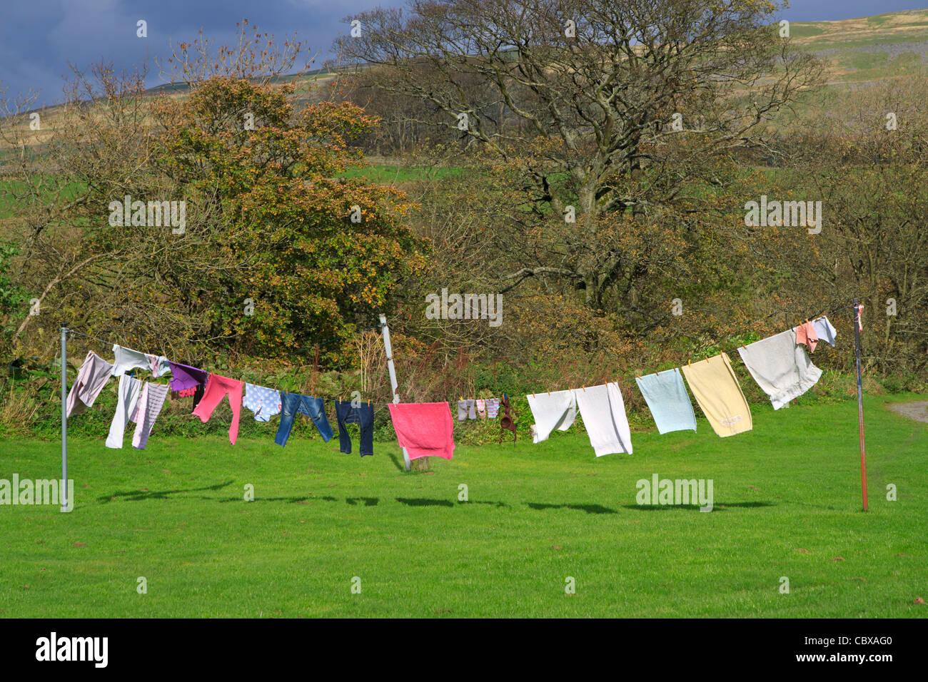 Clothes drying on a washing line on a windy autumn day, Yorkshire, UK Stock Photo