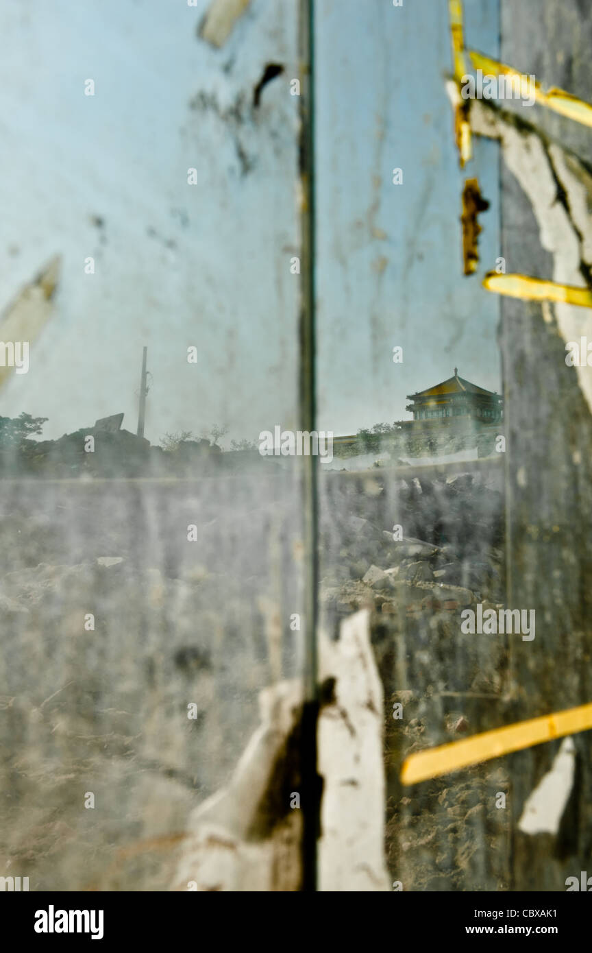 View through a glass door access to a building site with an old Chinese pavilion in the background Stock Photo