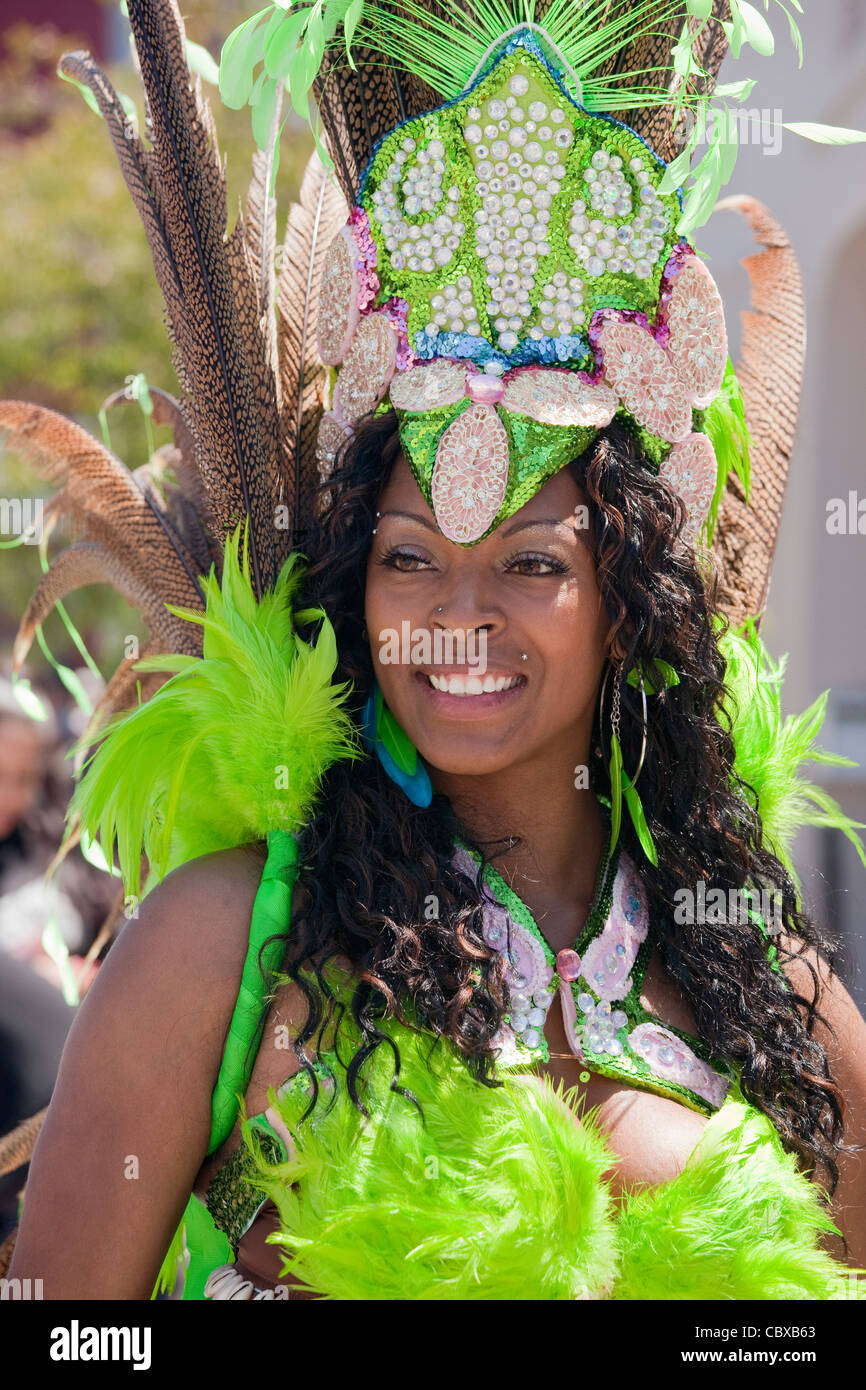 Woman in limegreen feathered costume and beaded headdress in annual