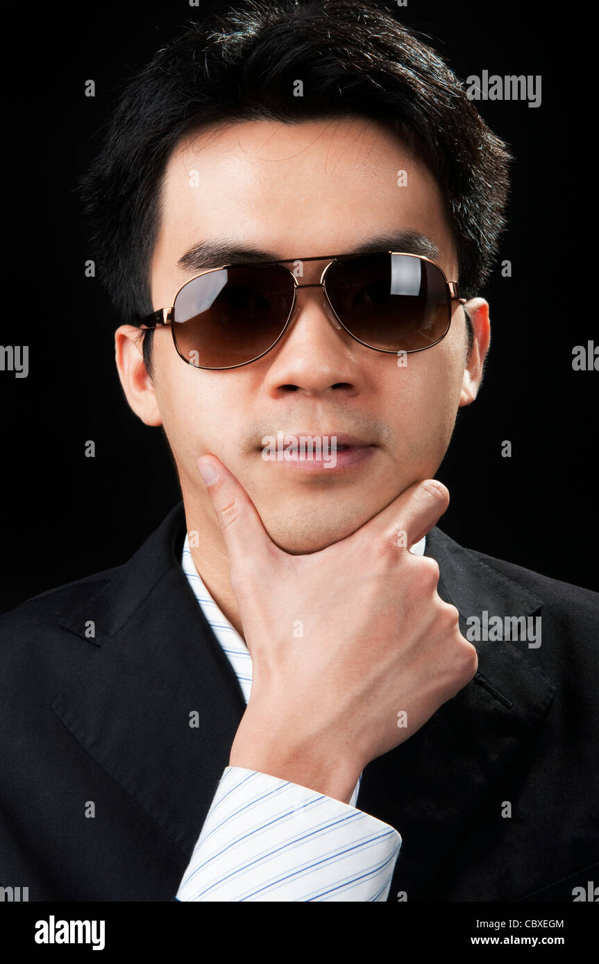 Portrait of a young man in suit and sunglasses Stock Photo - Alamy