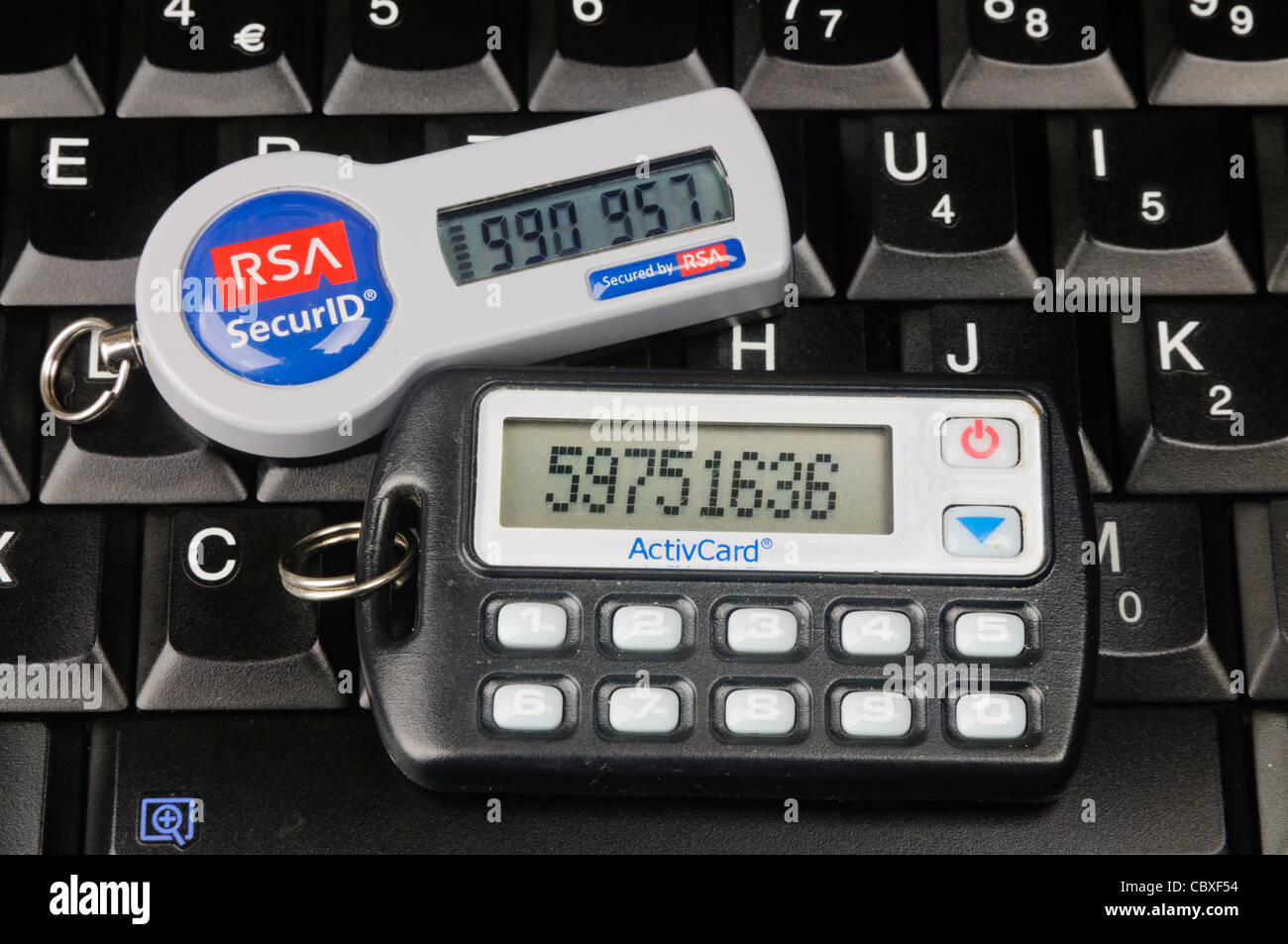 Two SecureID Tokens sitting on a computer keyboard Stock Photo