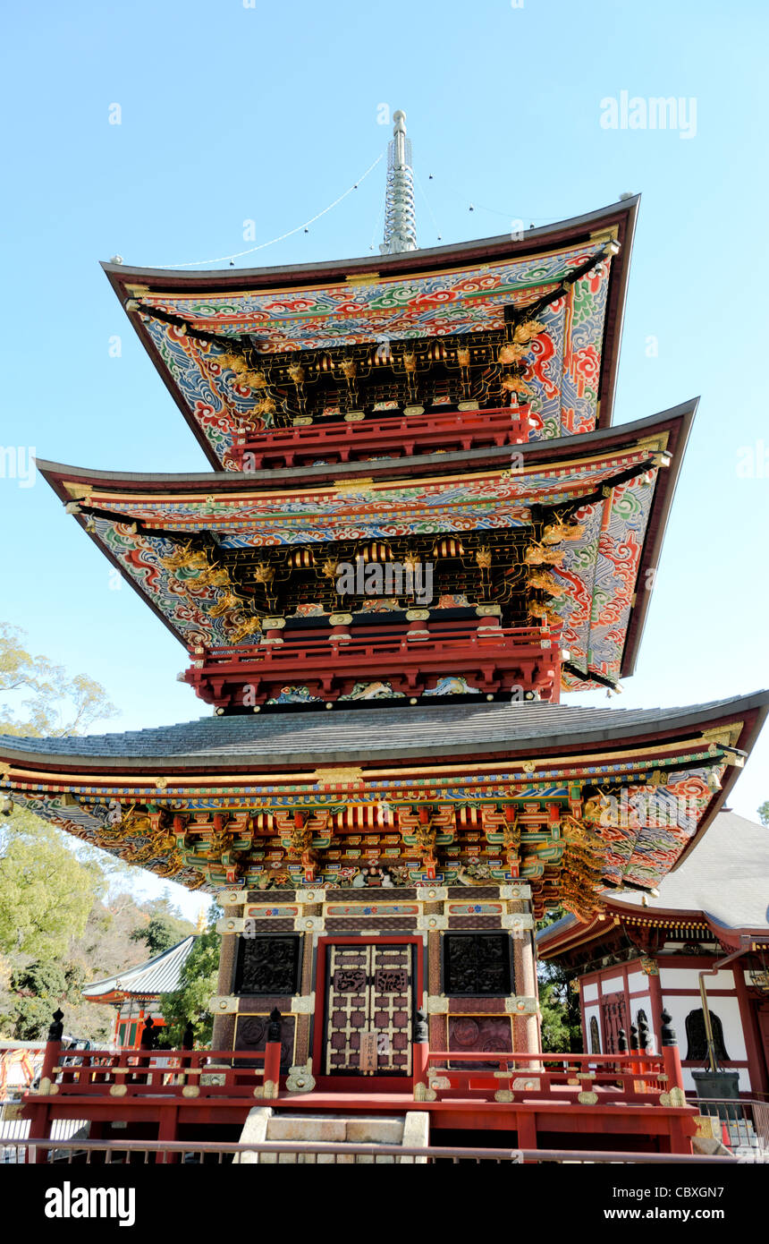 NARITA, Japan - The Three Storied Pagoda, standing 25 meters tall, was originally built in 1712. It is ornately decorated with brightly painted rafters, carved dragons, and sculptures of 16 RAKAN or Buddha's disciples how attained Nirvana. On the first floor's inner sanctum is GOCHI-NYORAI (Five Tathagas) who is believed to be endowed with the five wisdoms of Buddha. The Narita-san temple, also known as Shinsho-Ji (New Victory Temple), is Shingon Buddhist temple complex, was first established 940 in the Japanese city of Narita, east of Tokyo. Stock Photo