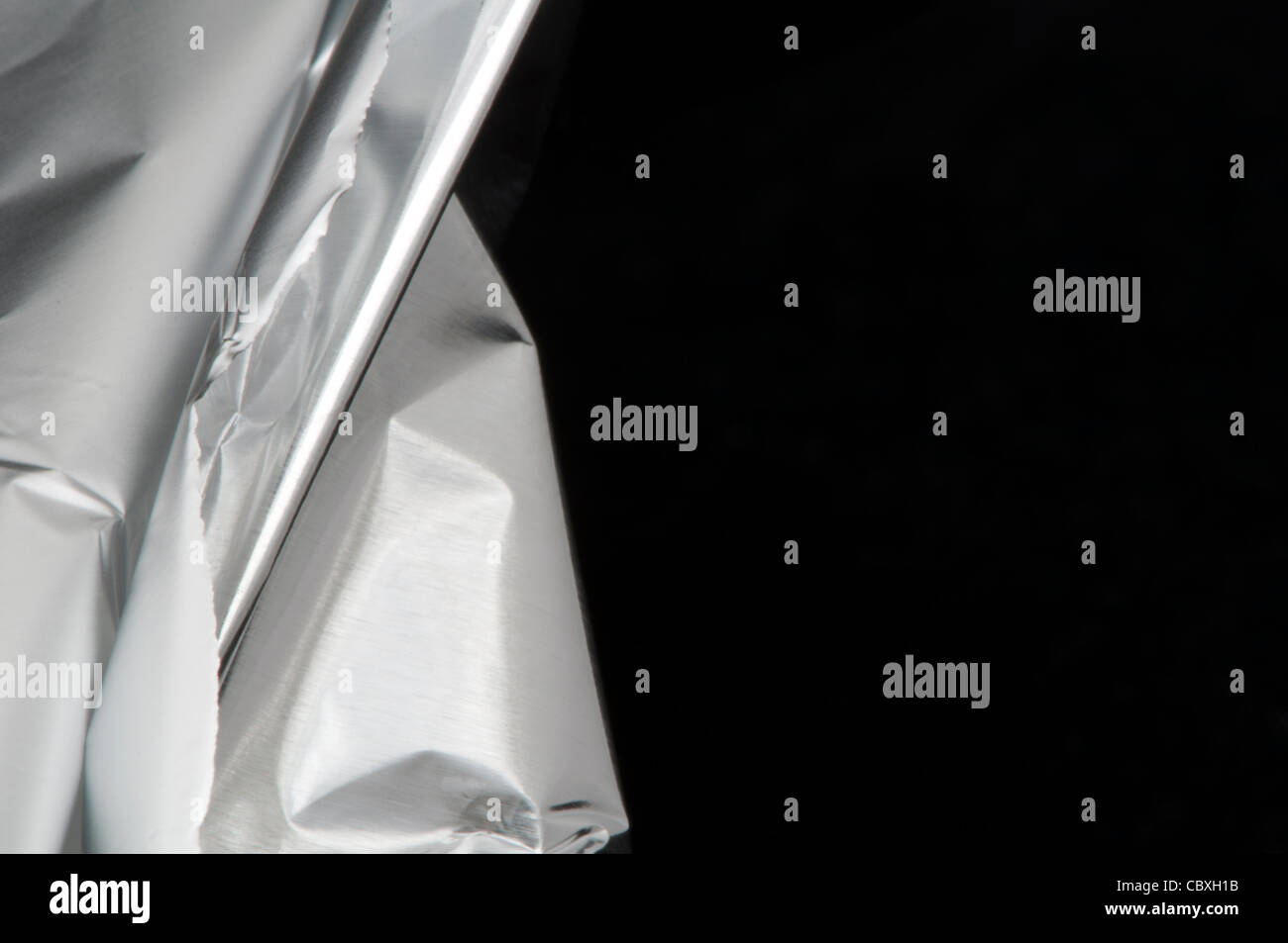 Cook Aluminum Foil on black background Stock Photo