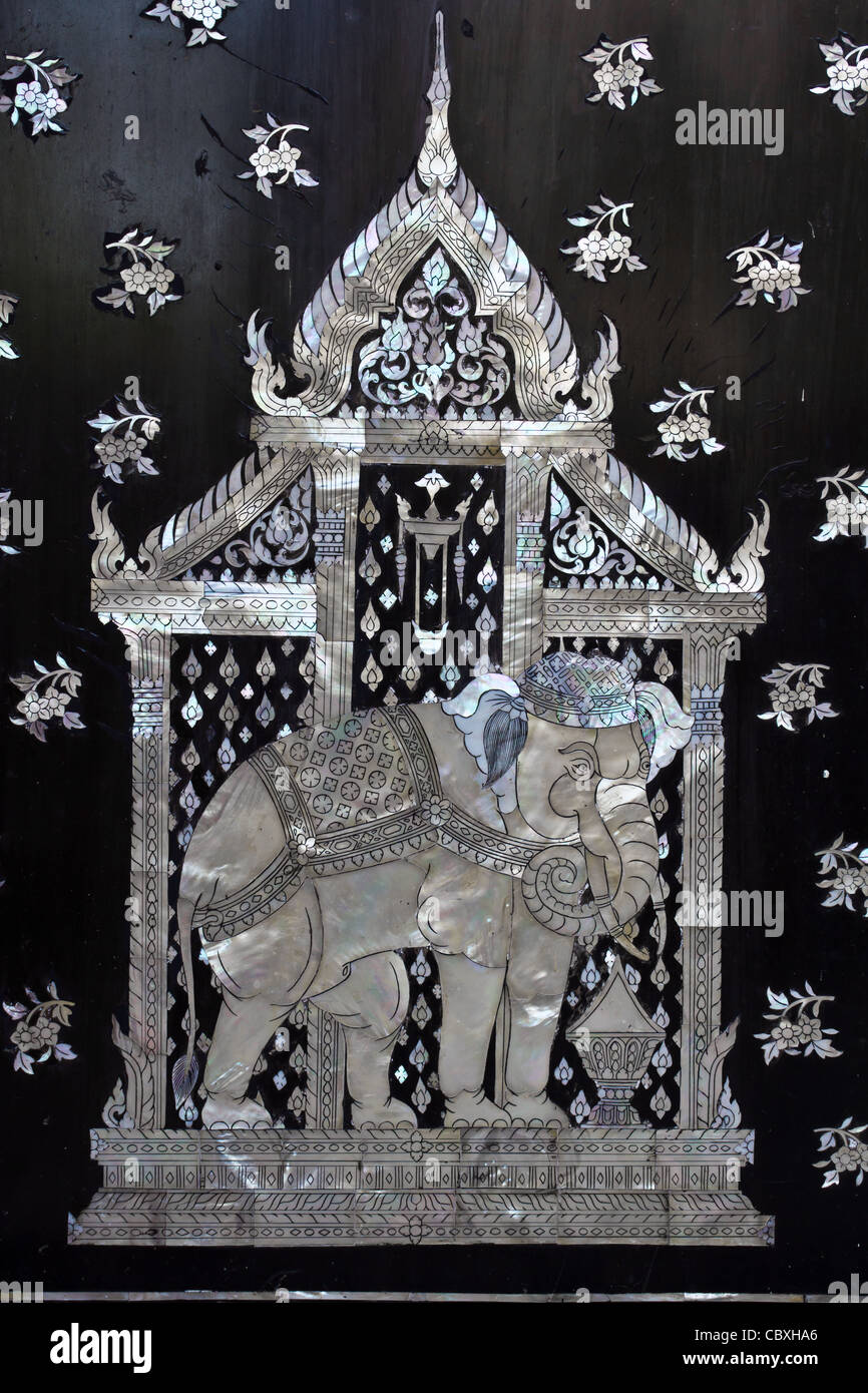 Traditional Thai style church door art, decorated with pieces oyster shell Stock Photo