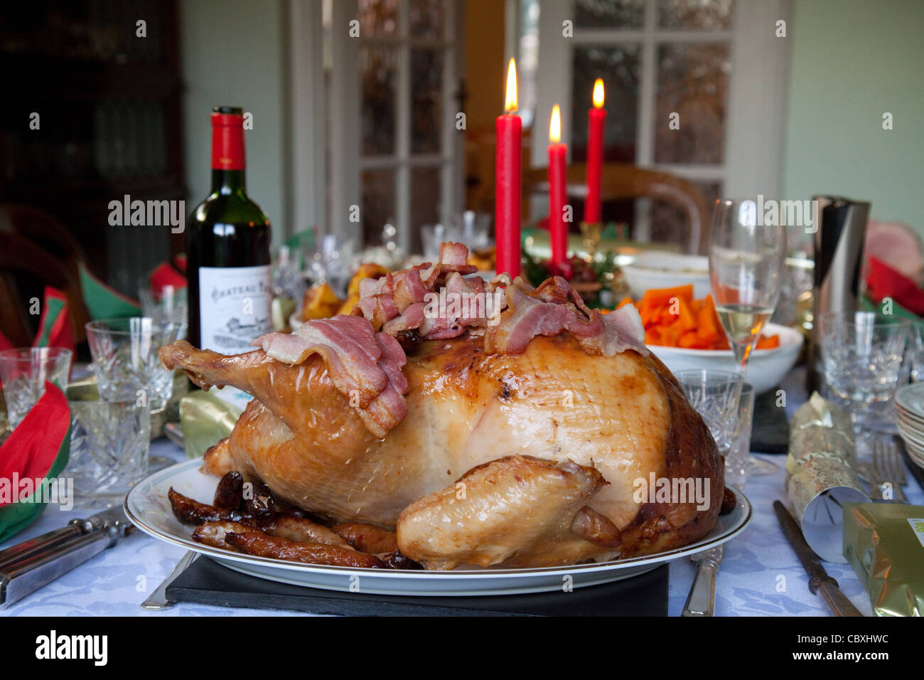 Roast turkey, claret and candles, a traditional christmas dinner table, UK Stock Photo