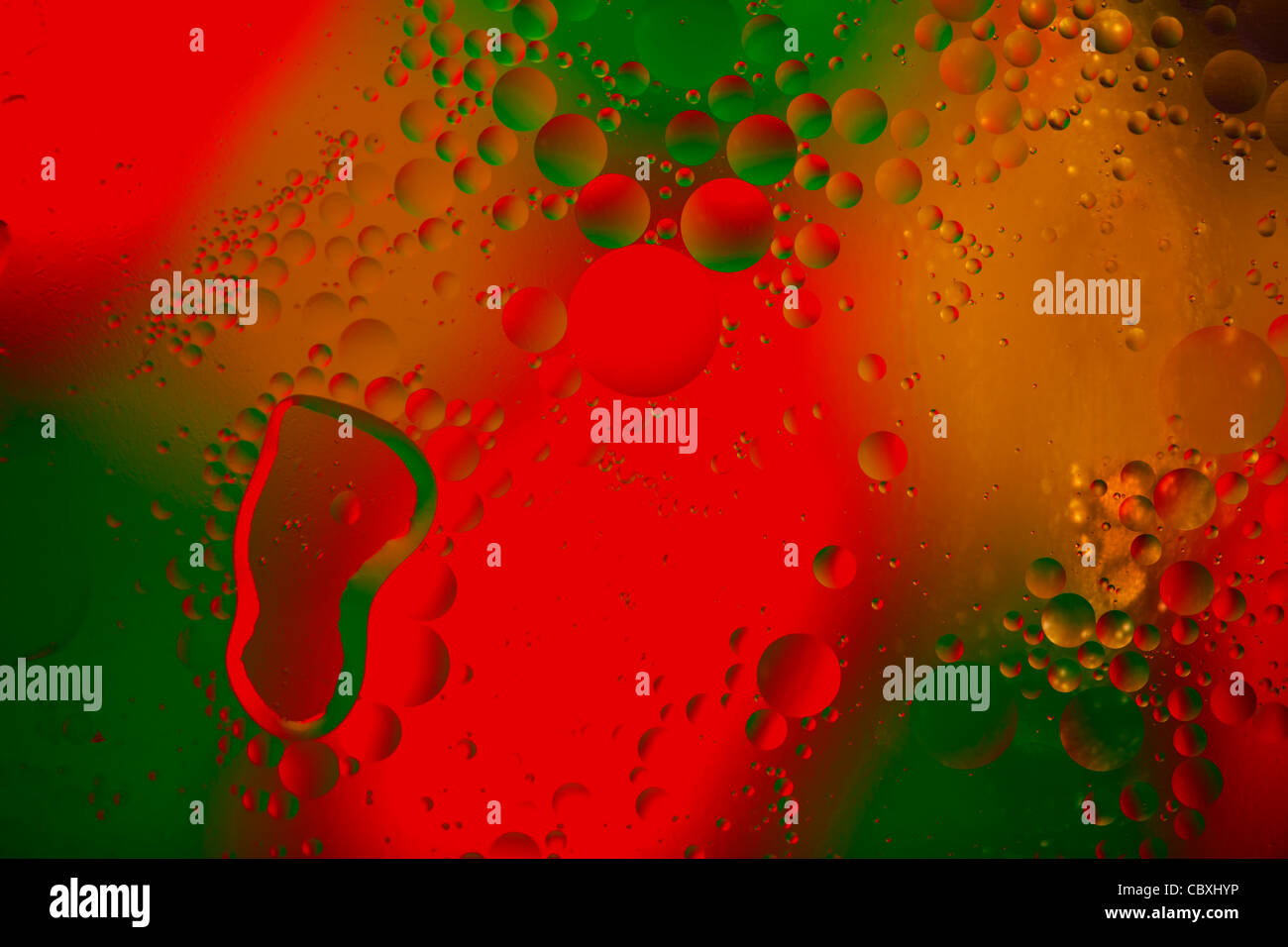 Oil and water with red, green and yellow background. Stock Photo