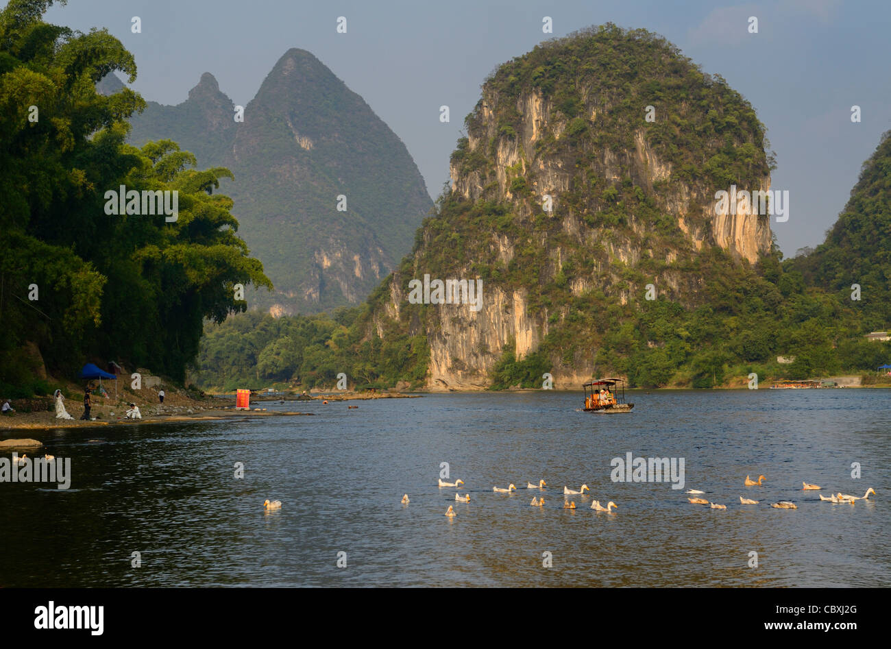 Bride and groom on the shores of the Li river with Karst peaks at Yangshuo Peoples Republic of China Stock Photo