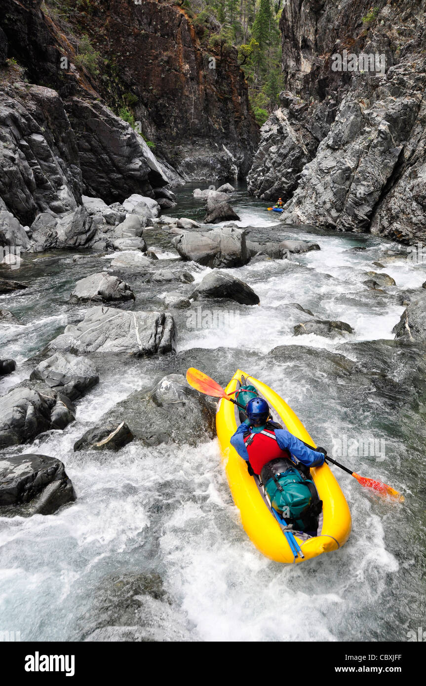 Paddling inflatable kayak down rapid on Oregon's Chetco River. Stock Photo