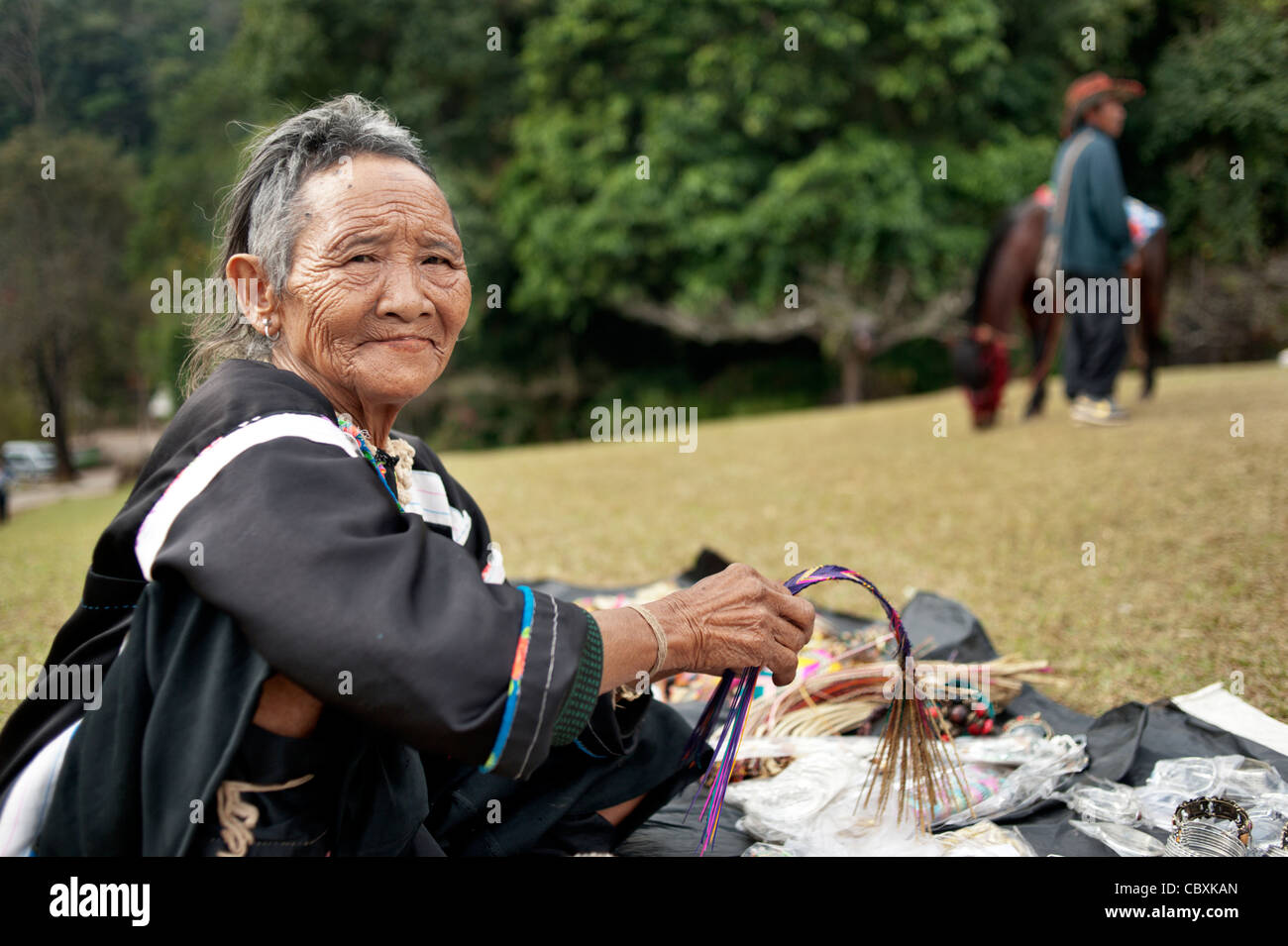 Senior hill tribe woman selling souviners at a royal project in north Thailand, Asia. Stock Photo