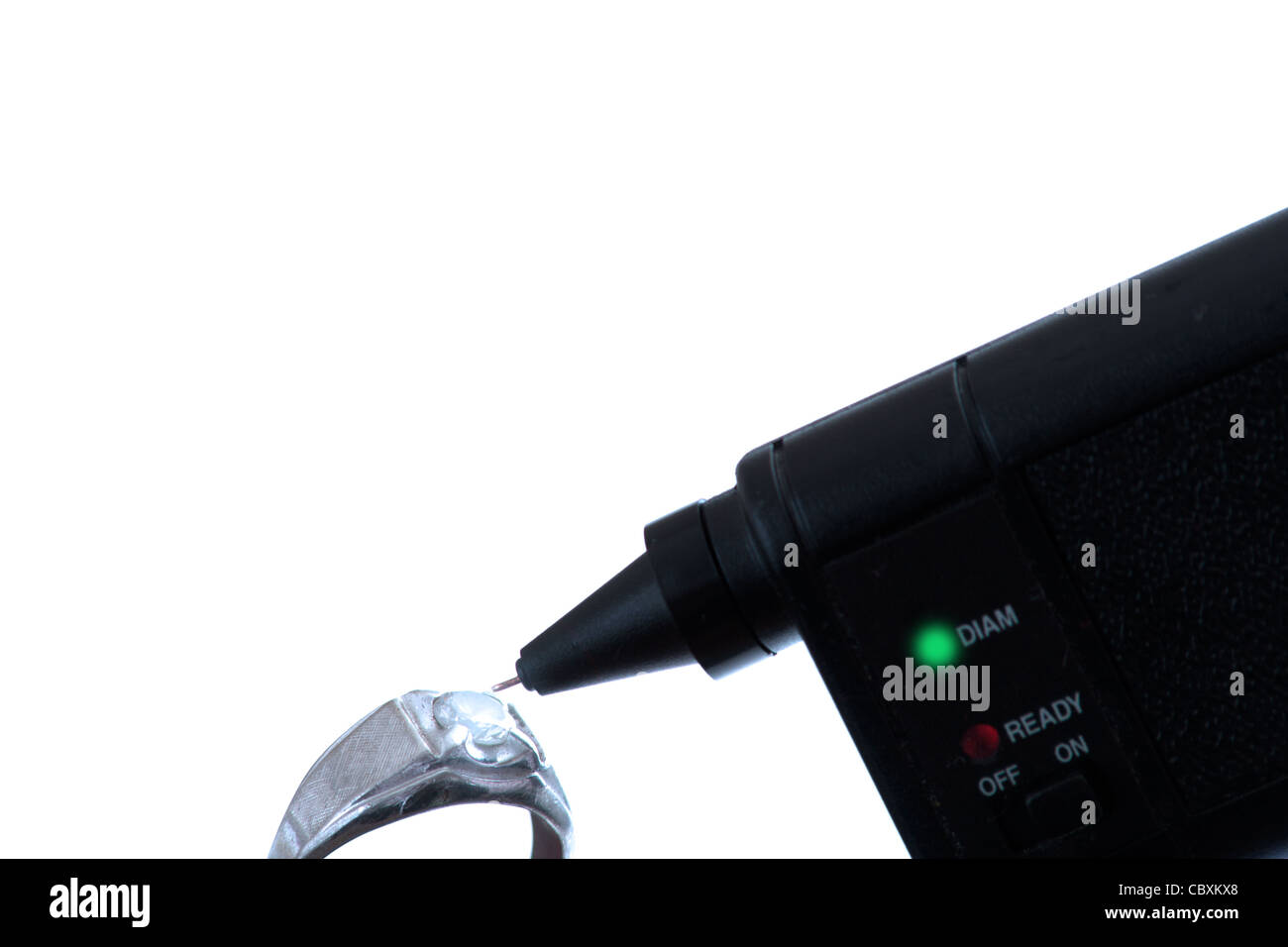 Diamond tester with ring in white gold Stock Photo Alamy