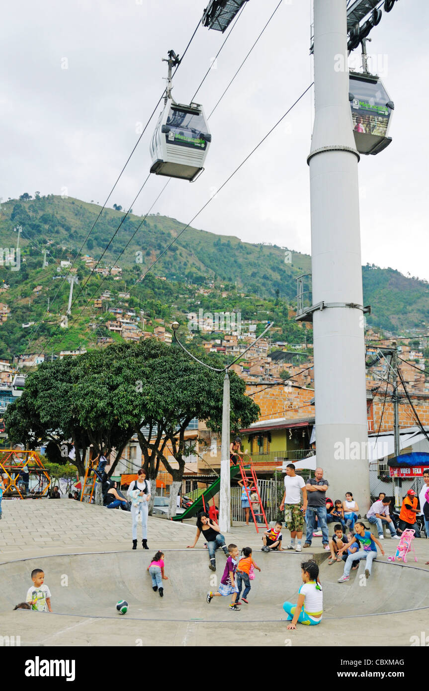 Children playing under the cablecar Metrocable, poor quarter Comuna 13, Medellin, Colombia, South America Stock Photo