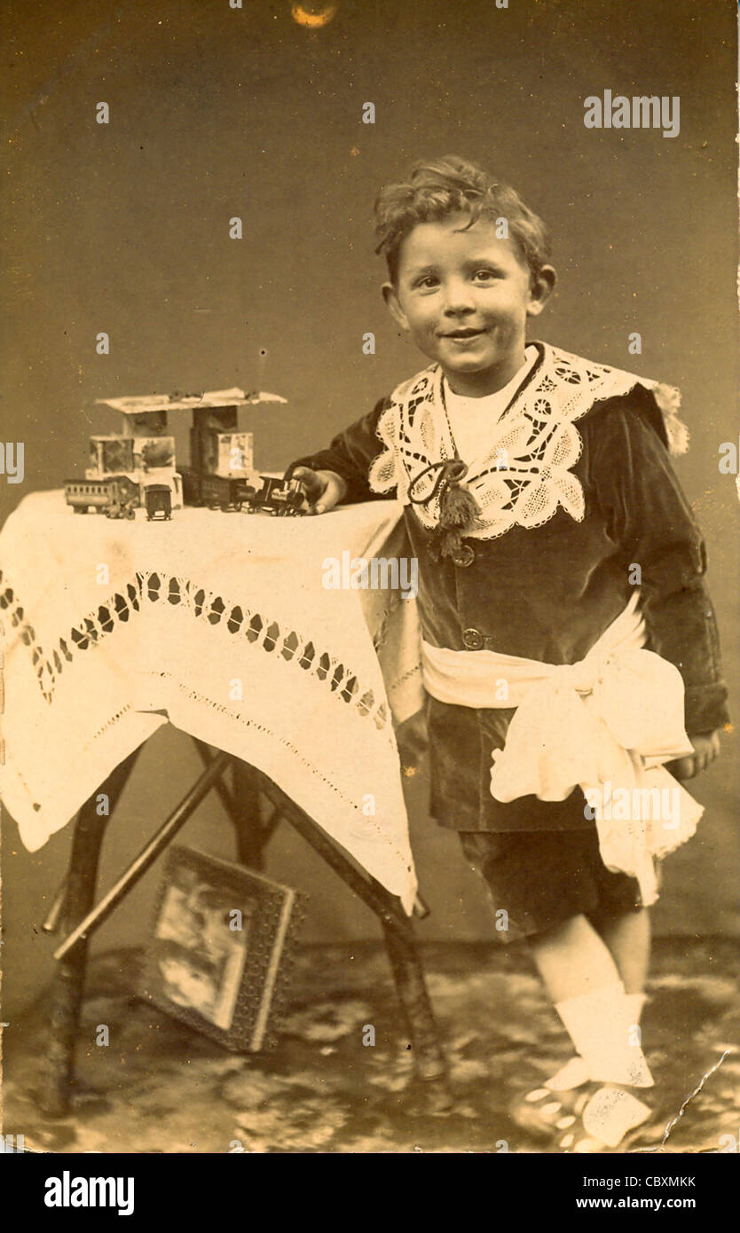 Photographic postcard of young boy with his toys Stock Photo