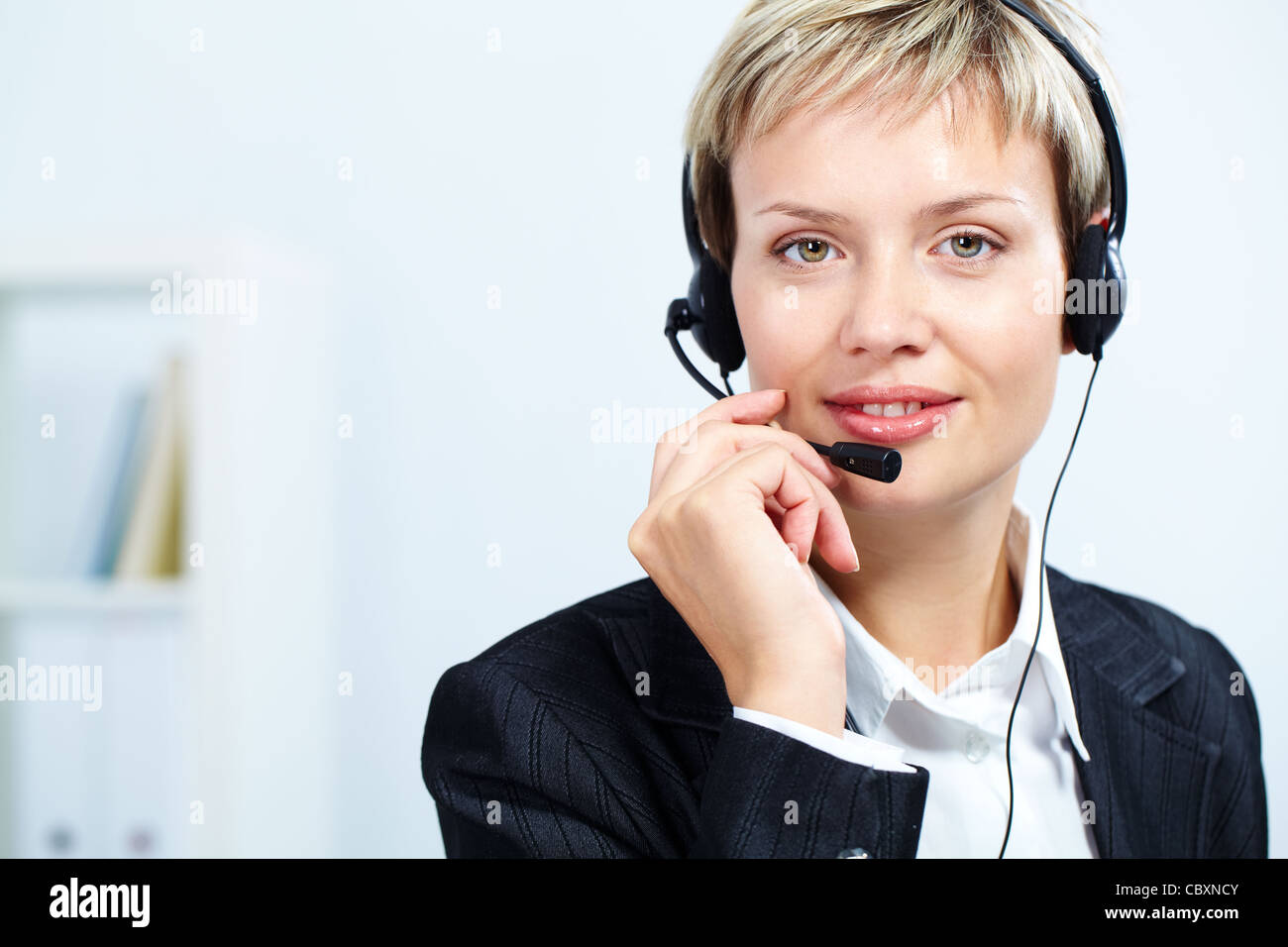 Portrait of attractive receptionist with headset Stock Photo - Alamy