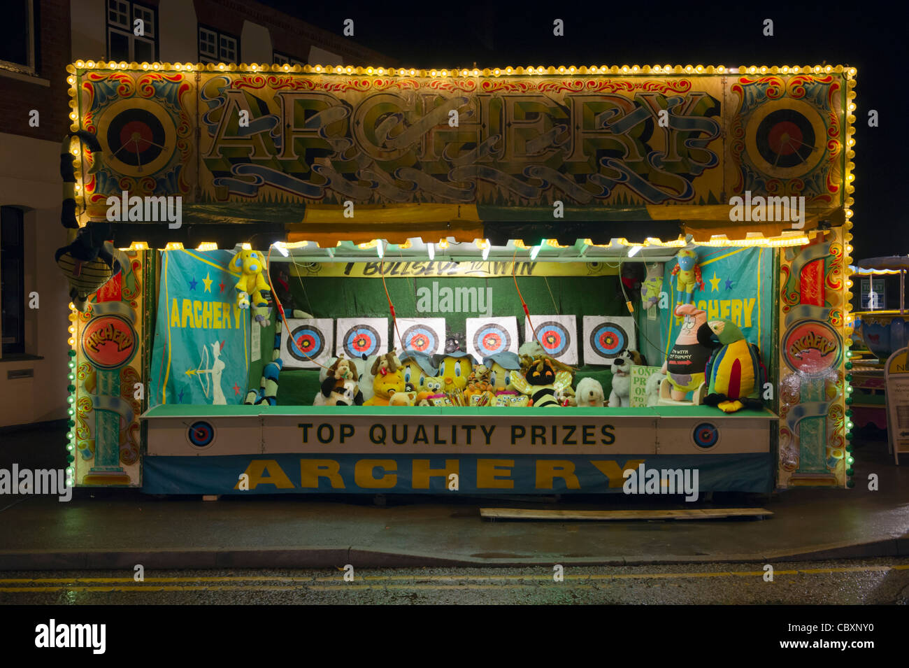 A fairground archery stall after dark at the Beaconsfield town annual Christmas Festival of Lights Bucks UK Stock Photo