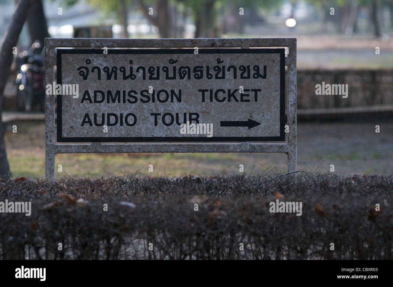 Bilingual admission ticket sign destroyed by flooding (water damage), Wat Mahathat, Ayutthaya, Thailand. credit: Kraig Lieb Stock Photo
