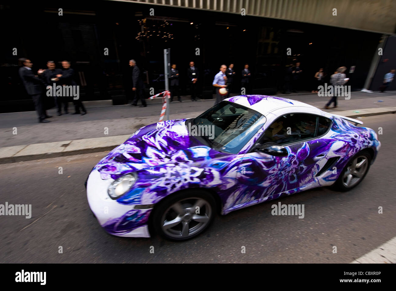 painted porsche cayman driving around milan Stock Photo