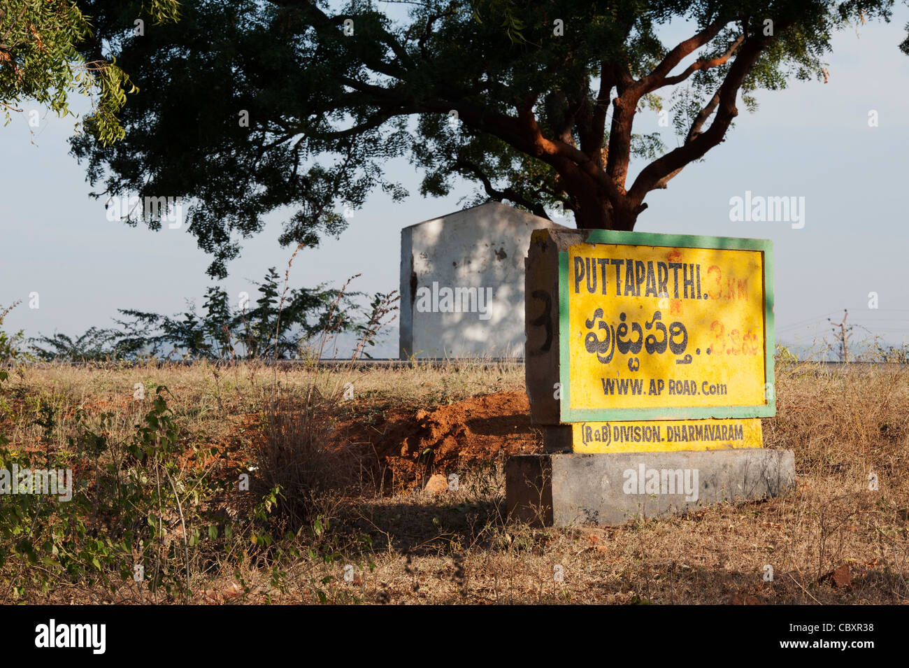 Concrete Puttaparthi road distance sign. Andhra Pradesh, India Stock