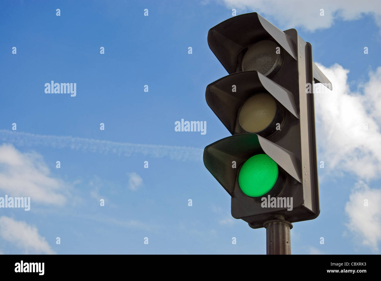 Green color on the traffic light with a beautiful blue sky in