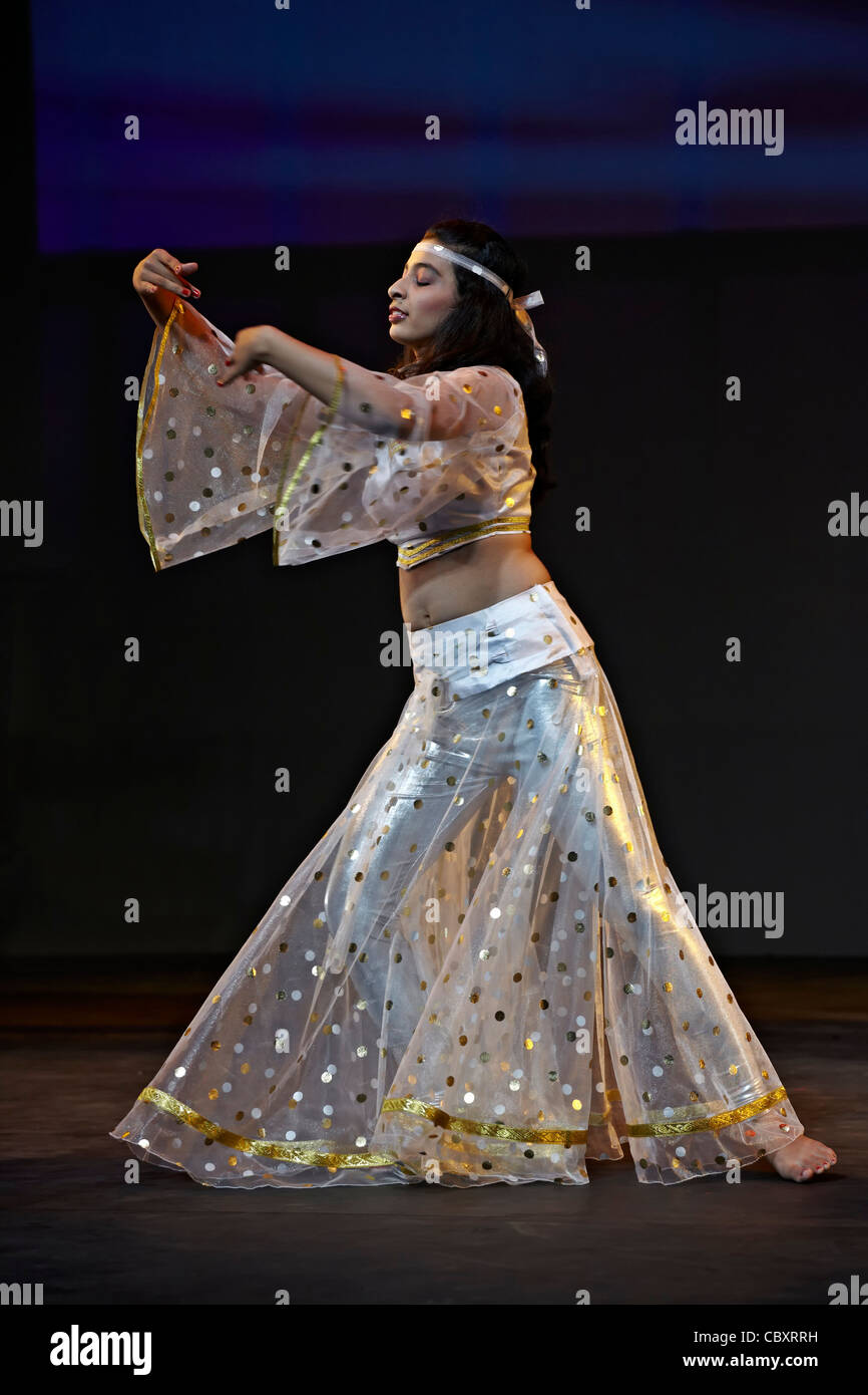 Asian Indian dancer performing on stage wearing traditional costume