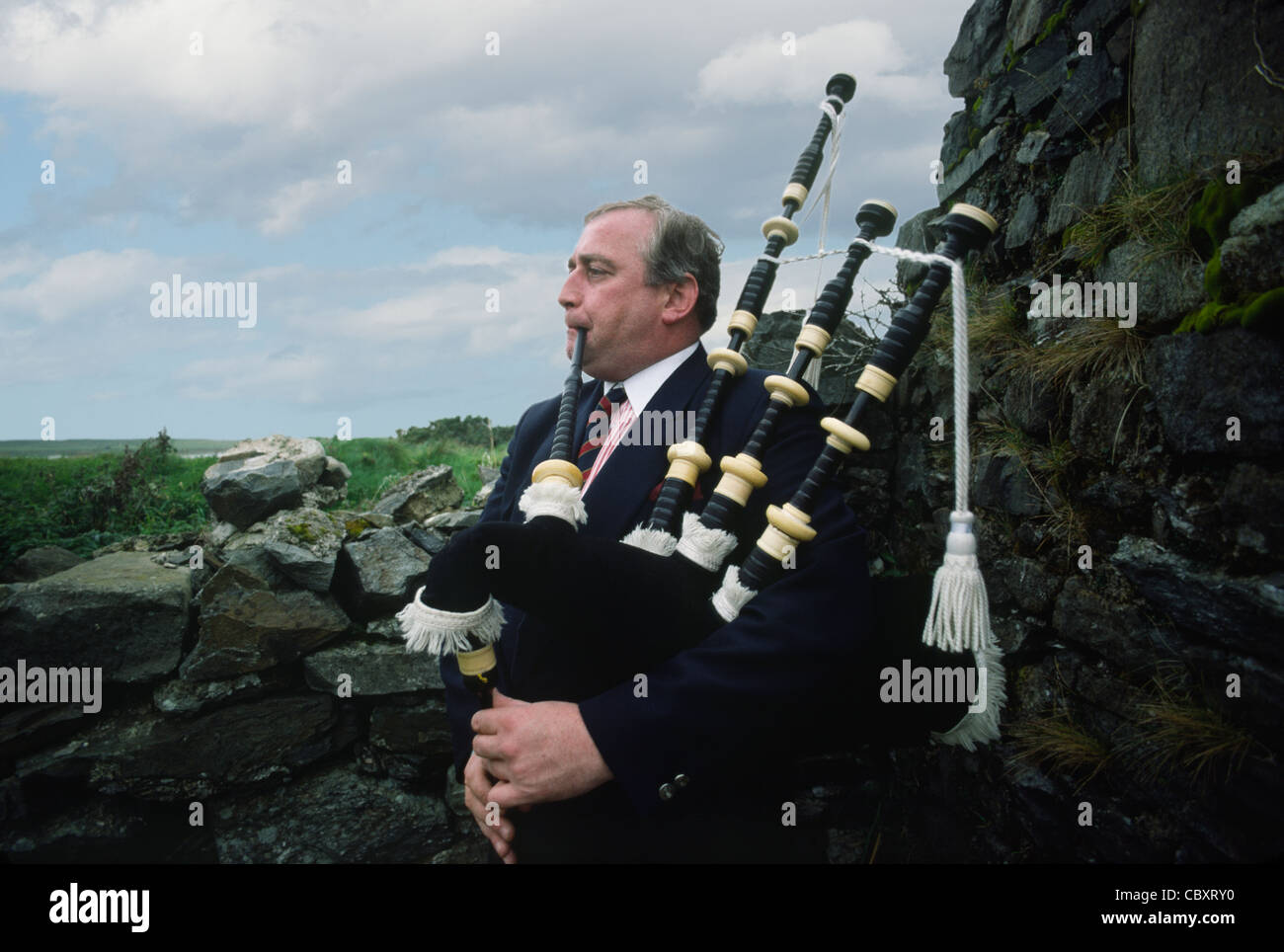 Man playing bagpipes in the wild Connemara district in the far west of