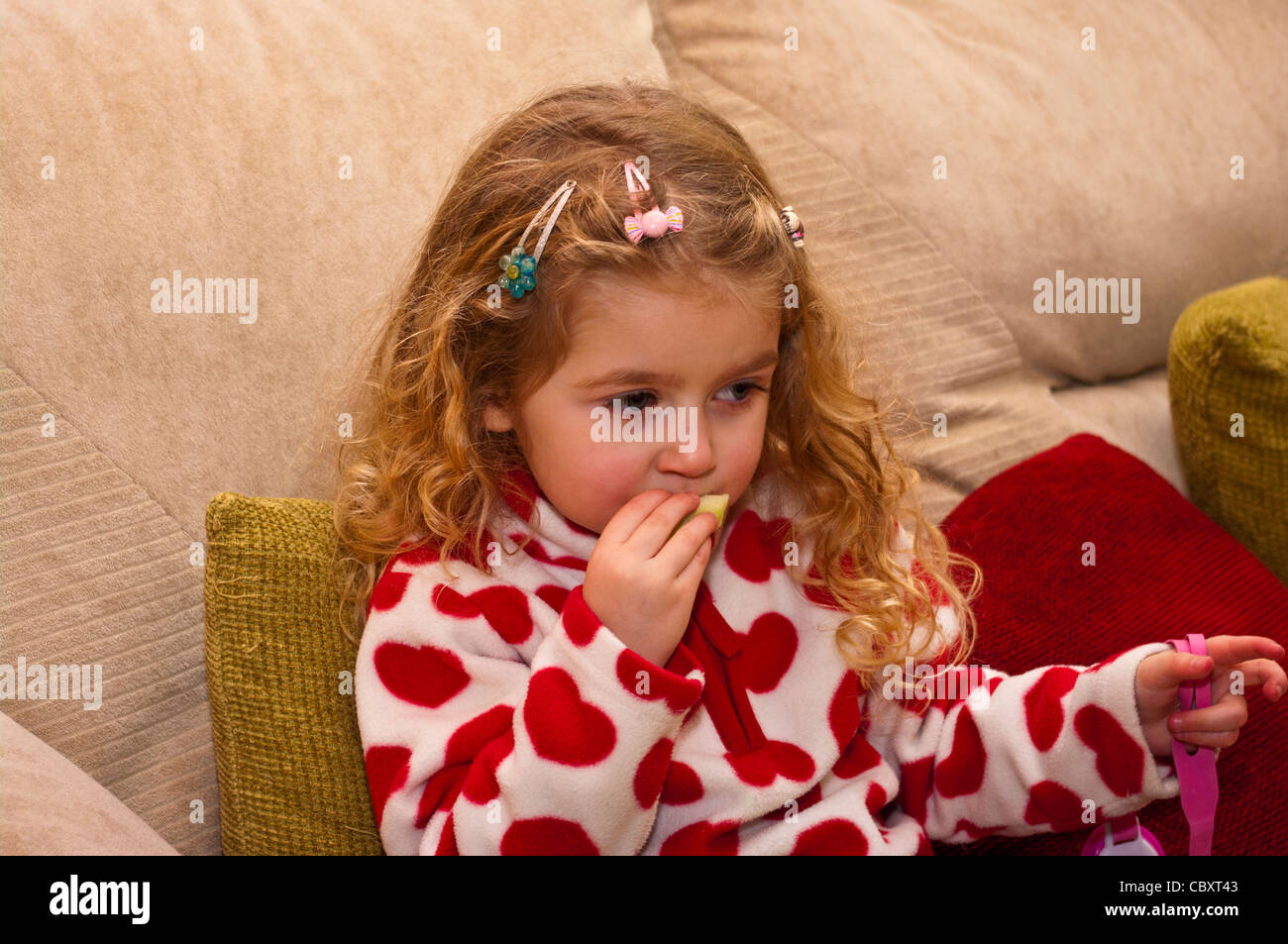 3 Year Old Child Girl Infant Toddler Eating A Slice Of Apple Fruit Stock Photo