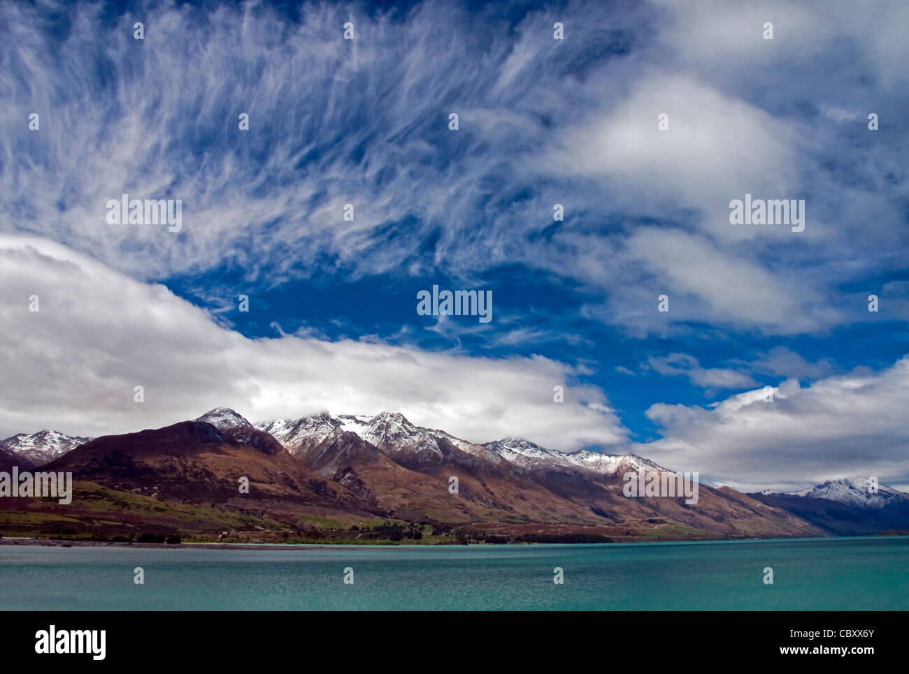 Clouds in early spring over Lake Wakatipu and the mountains near Queenstown, New Zealand. Stock Photo