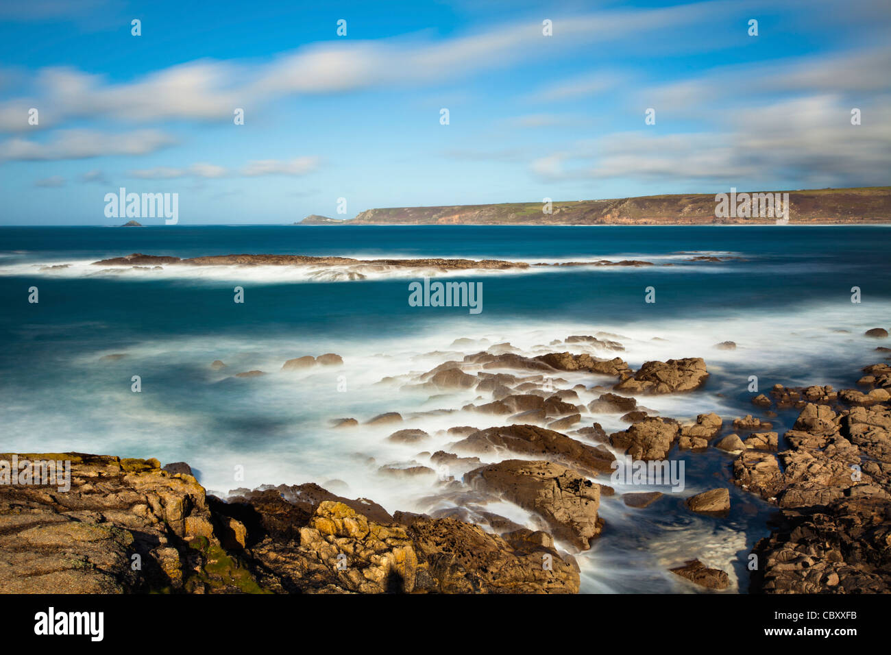 The view north from rocks near Sennen Cove towards Cape Cornwall.  Captured using a long shutter speed. Stock Photo
