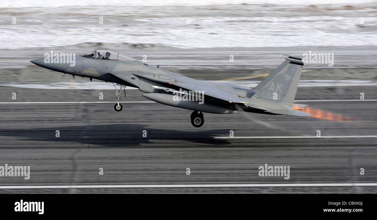 An F-15 Eagle takes off prior to a live fire training mission over an Alaskan range April 7, 2010, at Elmendorf Air Force Base, Alaska. The air-to-air gun mission consisted of a Cessna Conquest towing an aerial banner 2,000 feet behind it while two F-15 Eagles took turns firing at the banner. Stock Photo