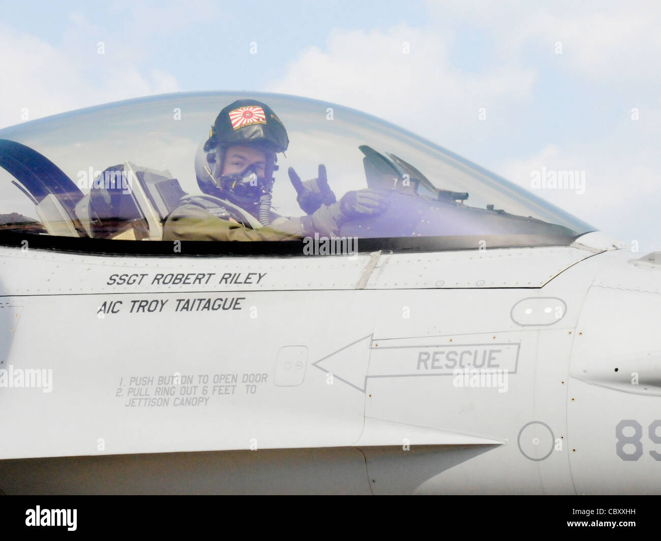 Capt. Ryan Cross flashes the samurai symbol as he taxis down the runway for takeoff March 11, 2010, at Tsuiki Air Base, Japan. During the aviation training relocation exercise F-16 Fighting Falcon pilots from Misawa AB, Japan, flew air combat missions against Japan Air Self-Defense Force F-2s and F-15s. Captain Cross is a 14th Fighter Squadron pilot. Stock Photo