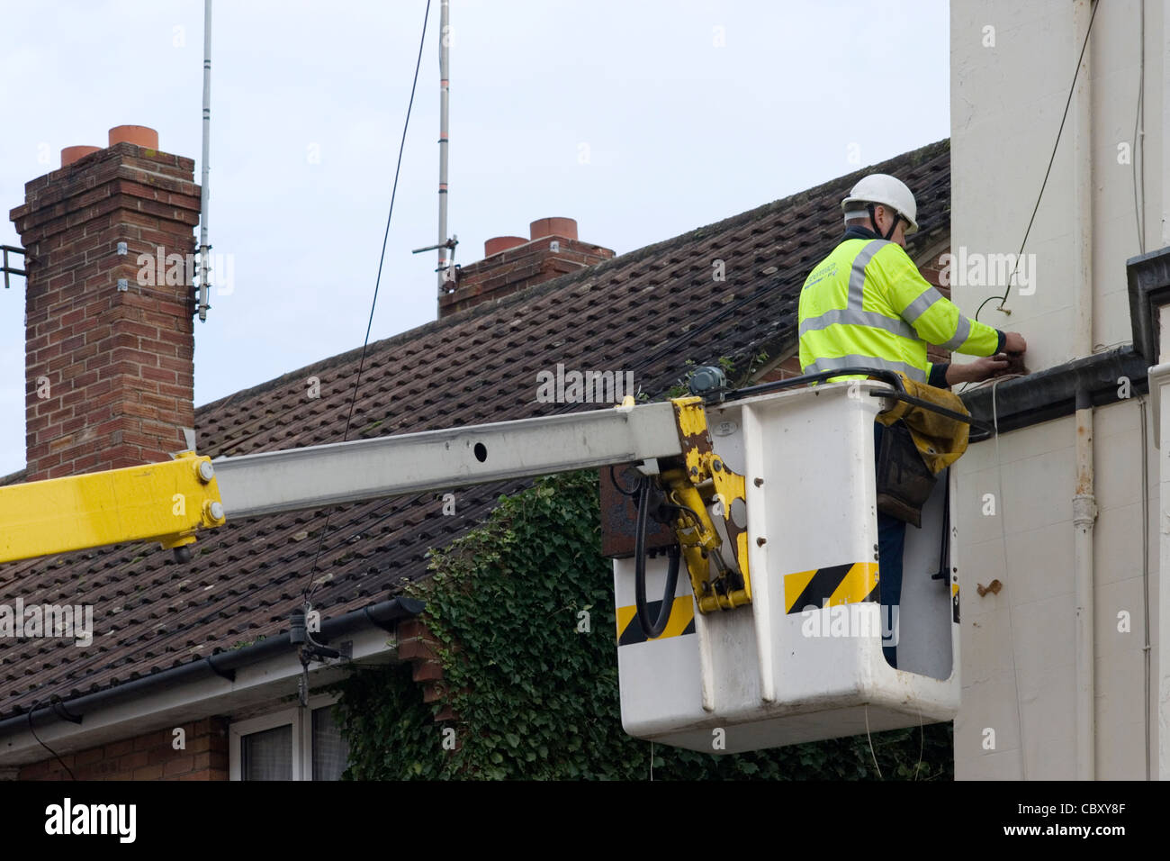 telephone engineer at work rewiring cables after replacing old