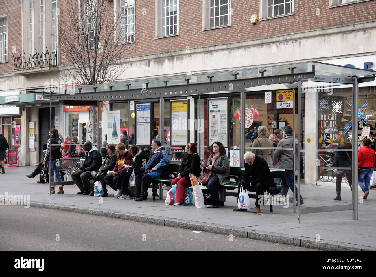 People waiting for a Bus queue queuing for stops and buses in Exeter