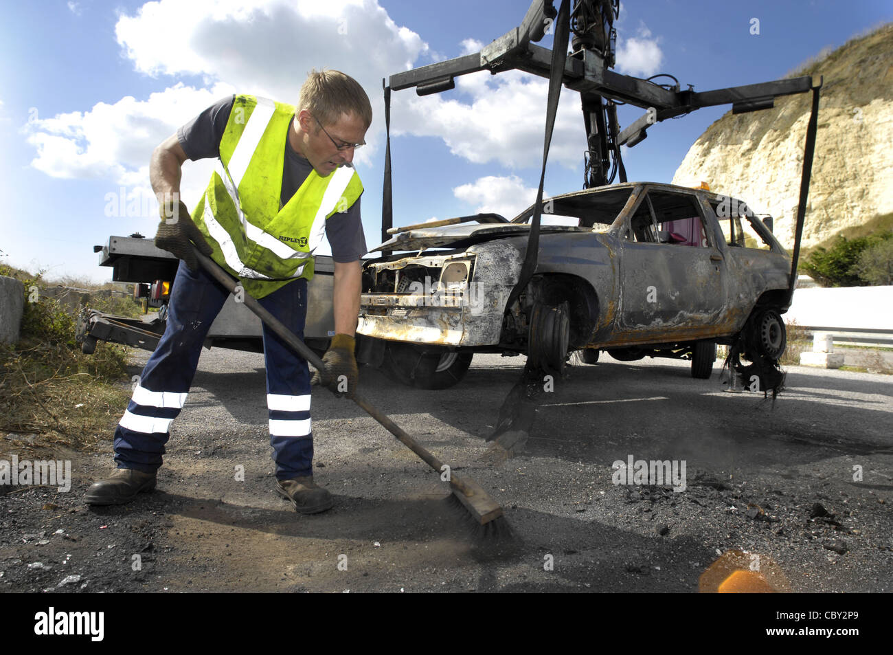 Burned out car being removed Stock Photo