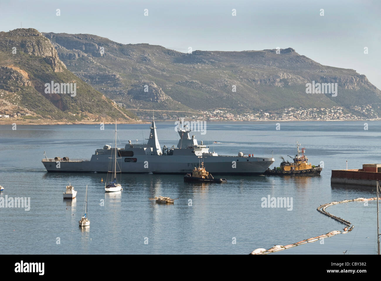 South African Navy frigate SAS Isandlwana with two tugboats at Simon's Town , South Africa Stock Photo
