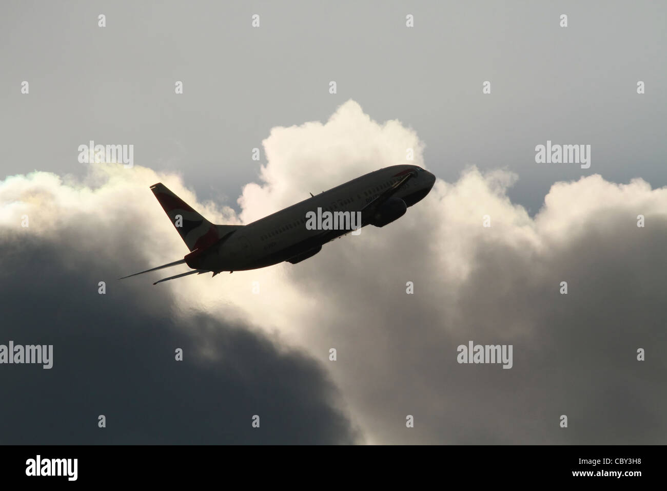 Jet airliner taking off into stormy sky Stock Photo