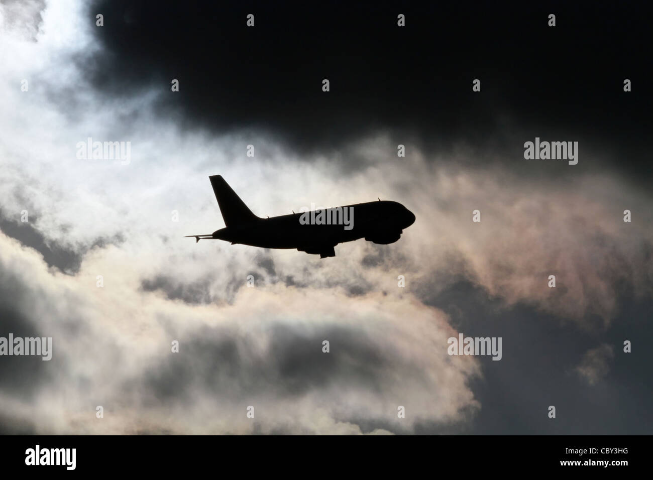 Jet airliner taking off into stormy sky Stock Photo