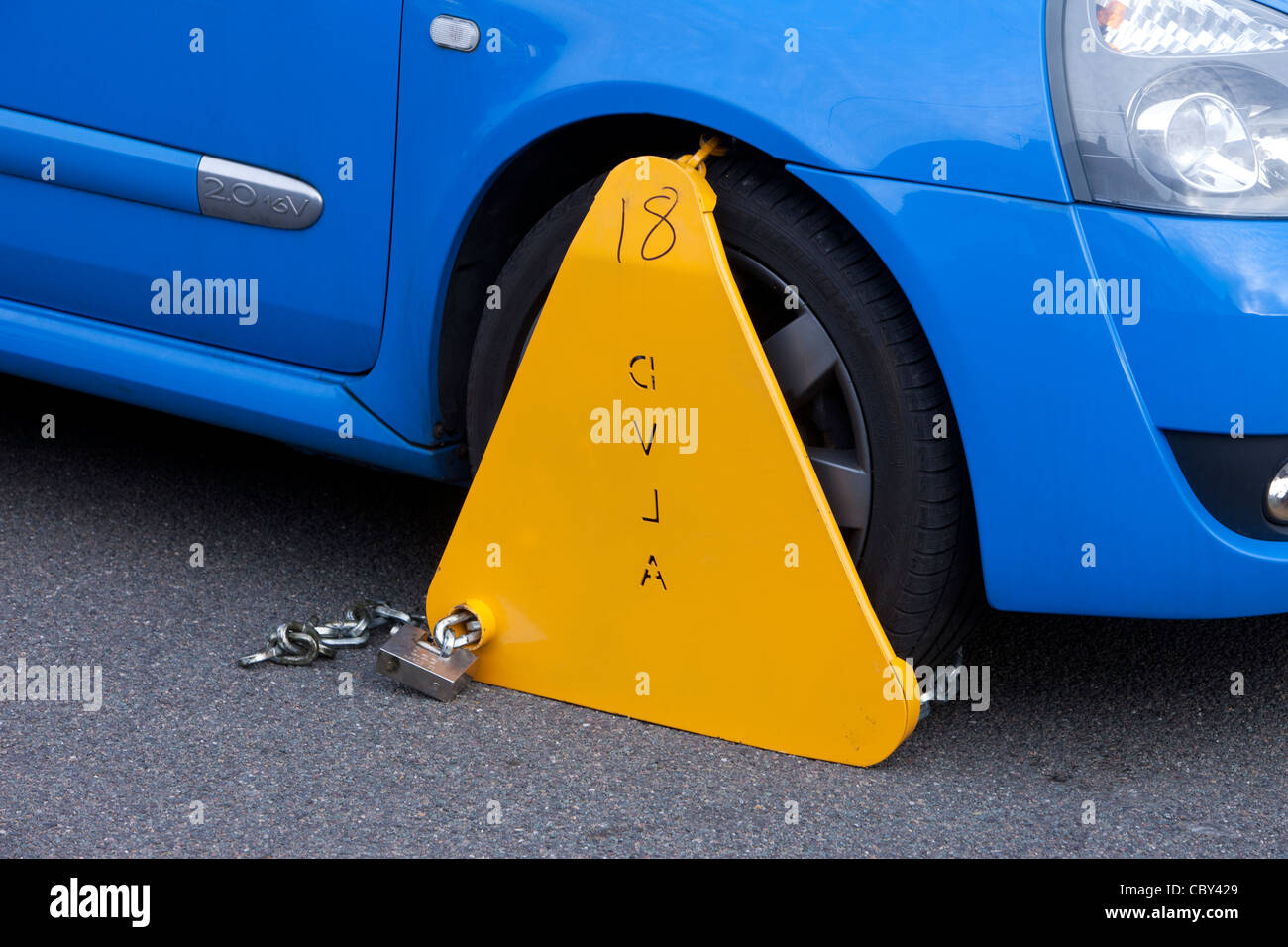 Untaxed vehicle with DVLA wheel clamp on a UK street Stock Photo Alamy