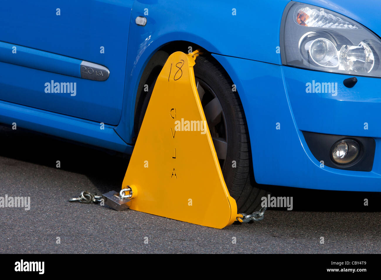 Untaxed vehicle with DVLA wheel clamp on a UK street Stock Photo
