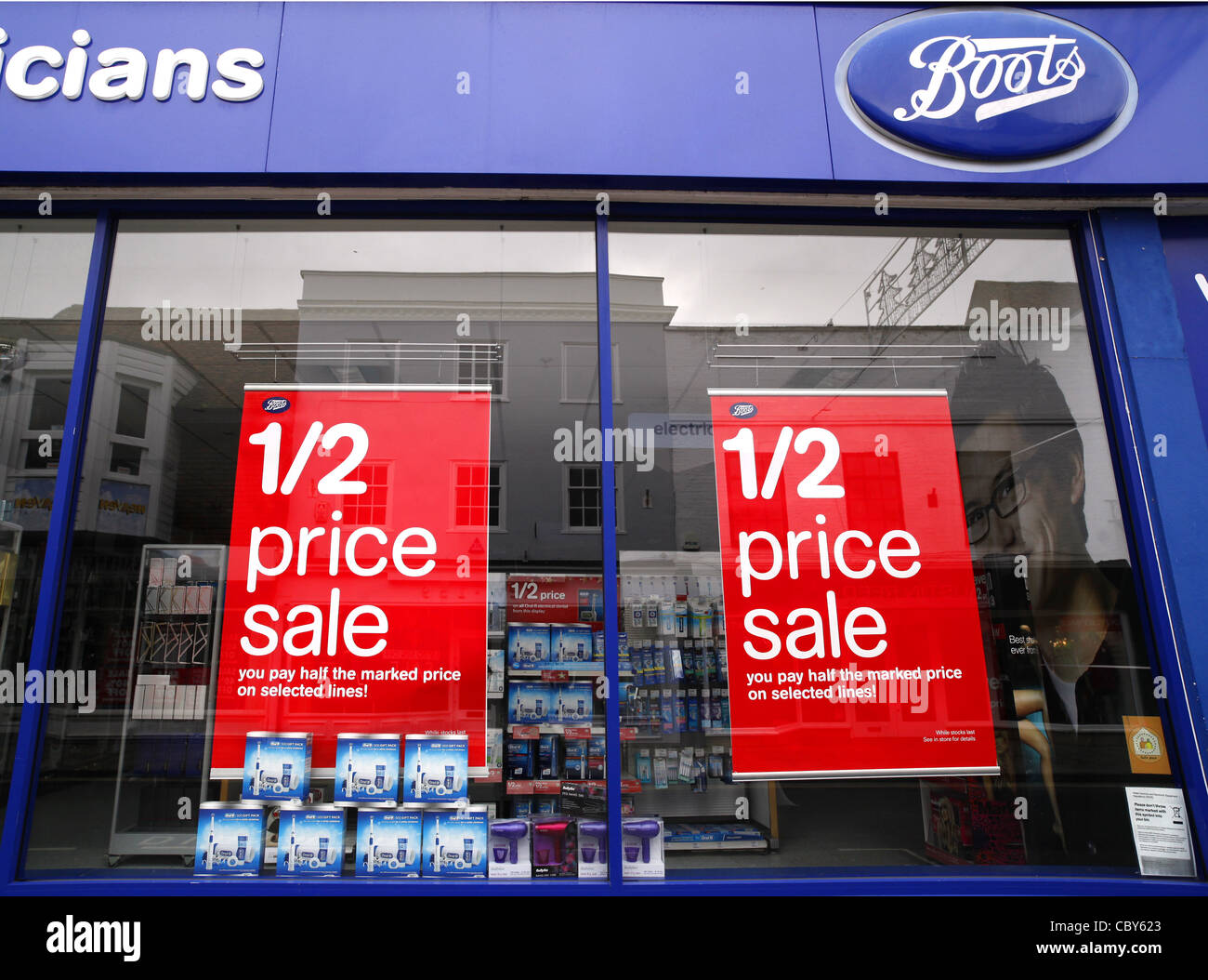 Boxing day sale posters in a Boots shop window Stock Photo - Alamy