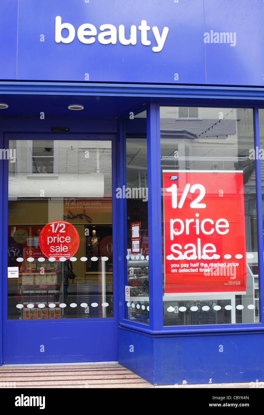 Boxing day sale posters in a Boots shop window Stock Photo - Alamy